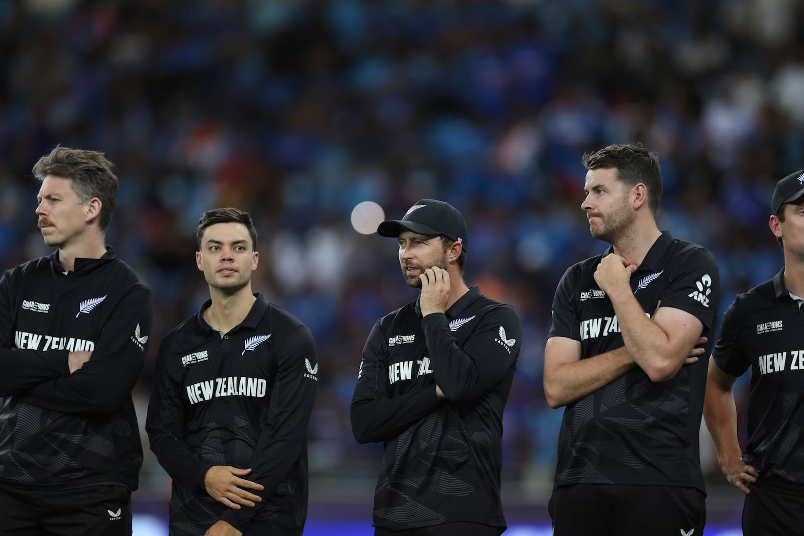 New Zealand's players wait for the award ceremony to begin after losing the ICC Champions Trophy final cricket match to India at Dubai International Cricket Stadium in Dubai, United Arab Emirates, Sunday, March 9, 2025. (AP Photo/Christopher Pike)