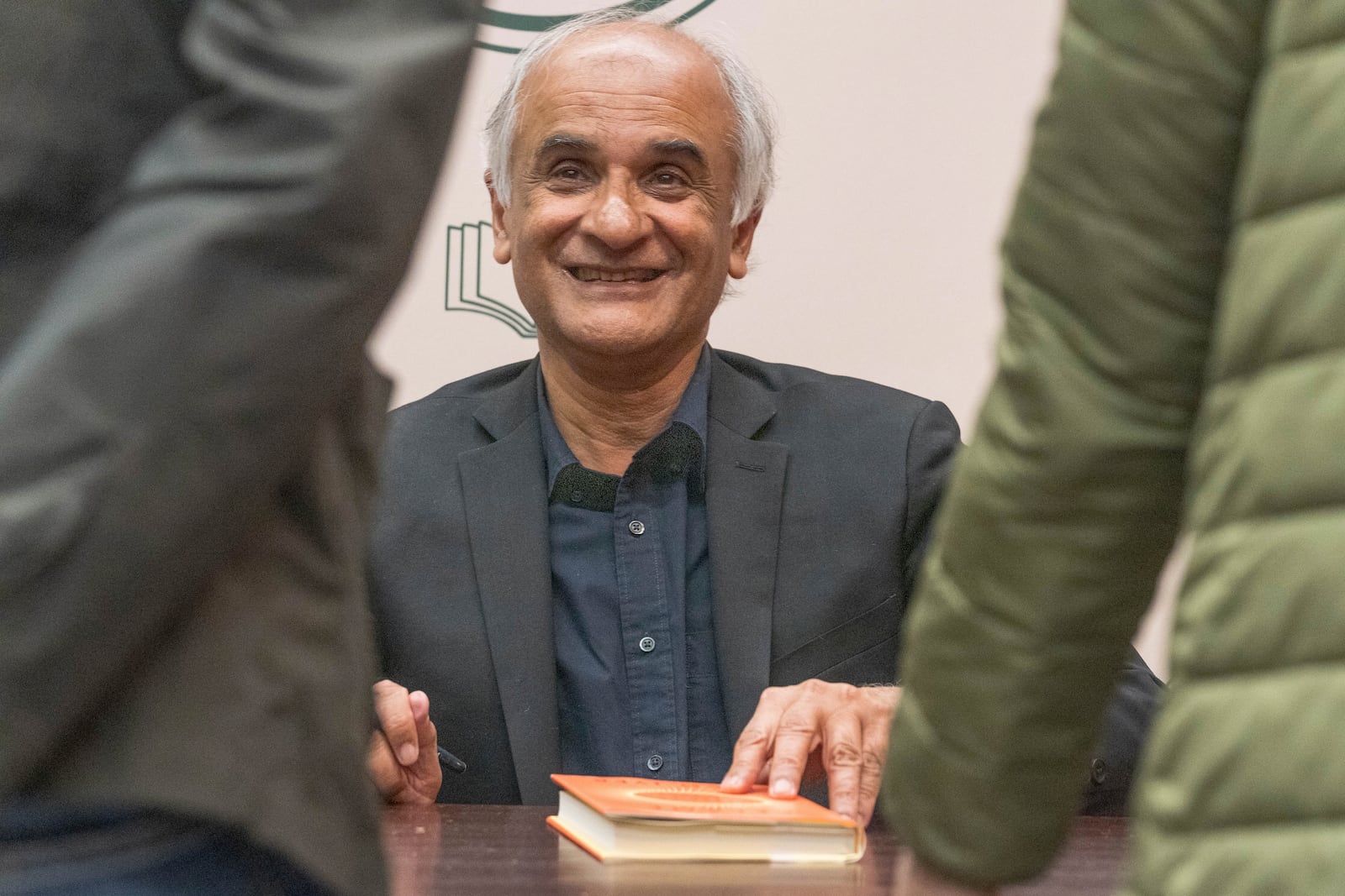 Pico Iyer, the bestselling author of "The Art of Stillness," presents his new book "Aflame: Learning from Silence" at Vroman's bookstore in Pasadena, Calif., on Tuesday, Jan. 28, 2025, in the wake of the devastating Eaton Fire that recently swept through parts of Pasadena and Altadena, forcing over 30,000 people to evacuate and burning thousands of structures. (AP Photo/Damian Dovarganes)