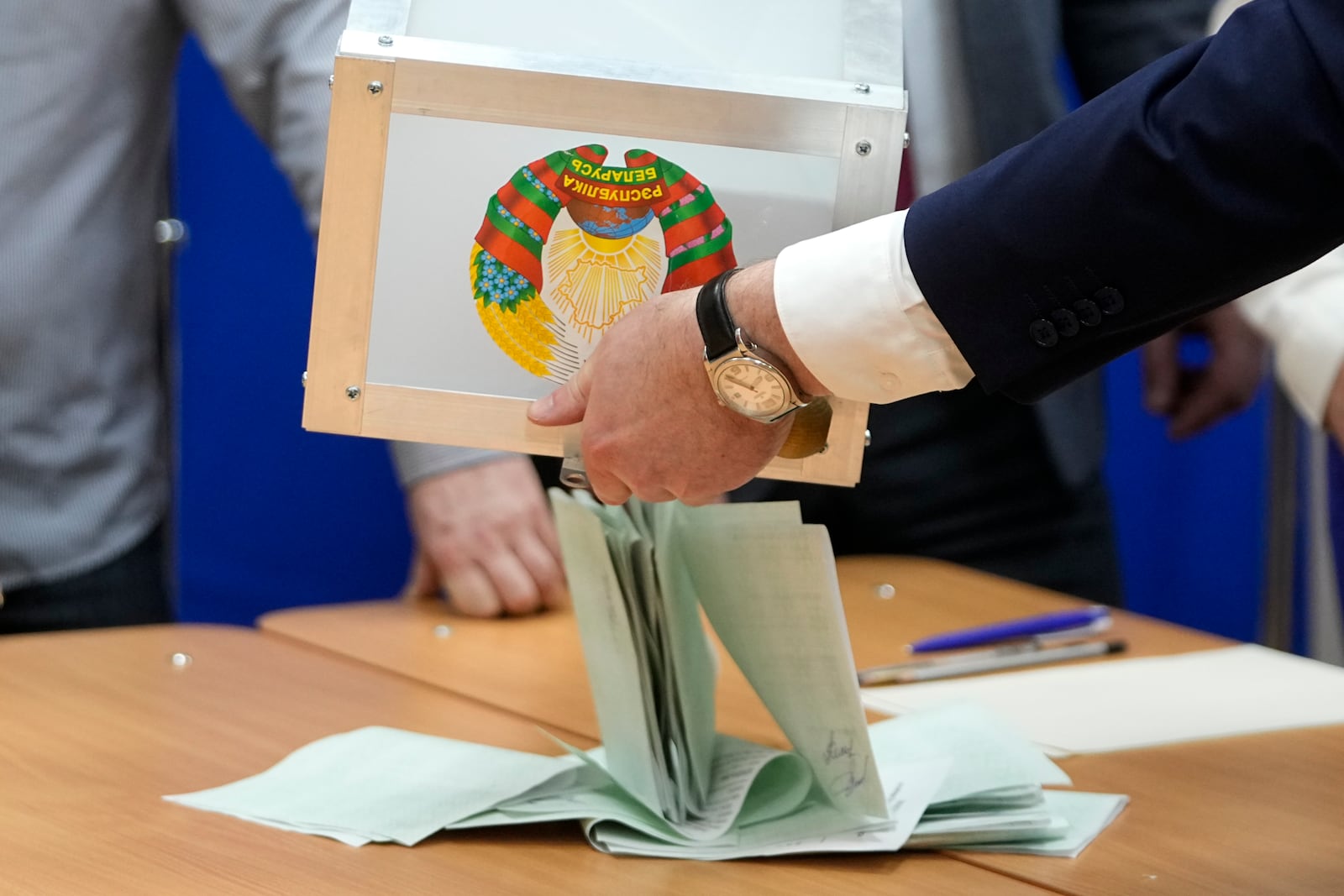 Election commission members prepare to count ballots for the presidential election at a polling station in Minsk, Belarus, Sunday, Jan. 26, 2025. (AP Photo/Pavel Bednyakov)