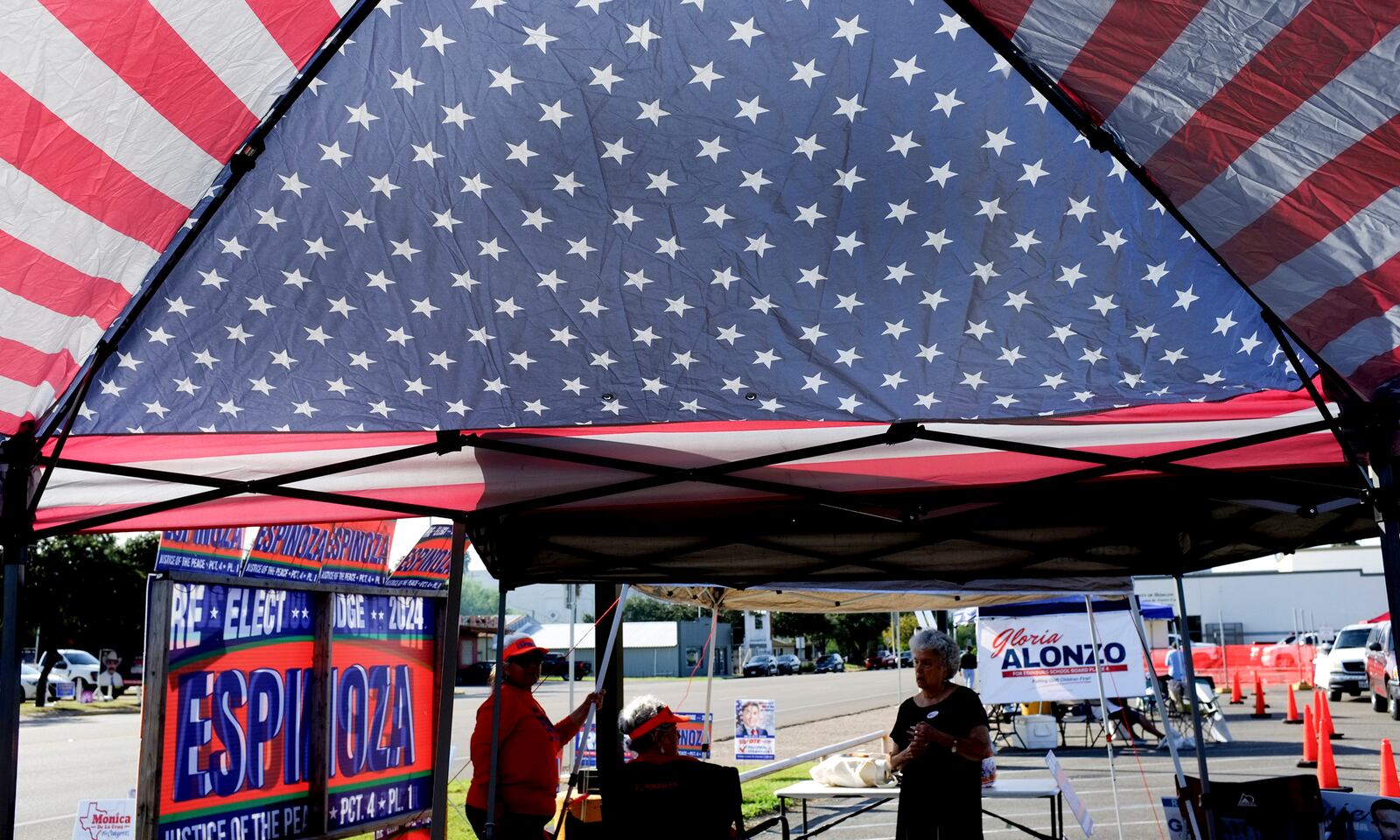 FILE - Local candidates are seen under a patriotic canopy during early voting at the Hidalgo County Annex, Oct. 21, 2024, in Edinburg, Texas. (Delcia Lopez/The Monitor via AP, File)