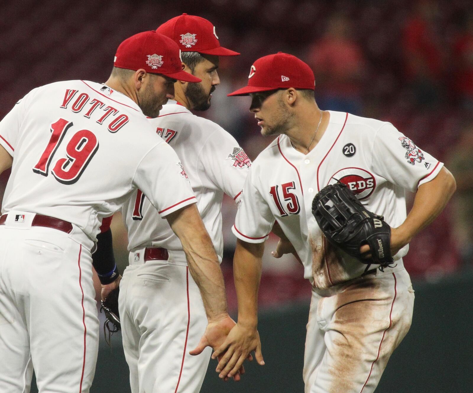 Reds players (left to right) Joey Votto, Eugenio Suarez and Nick Senzel celebrate after a victory against the Angels on Tuesday, Aug. 6, 2019, at Great American Ball Park in Cincinnati. David Jablonski/Staff