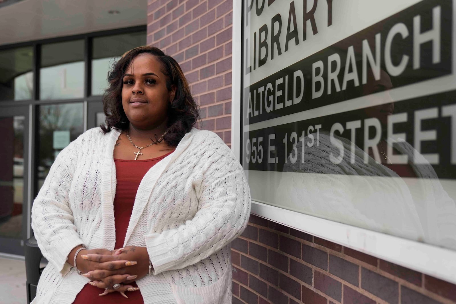 Adella Bass, health equity director with the People for Community Recovery environmental organization, stands outside the branch of the Chicago Public Library on the far South Side in the Altgeld Gardens community where she lives and works, Thursday, Dec. 19, 2024, in Chicago, where the Chicago Transit Authority plans to expand the Red Line train route. (AP Photo/Erin Hooley)