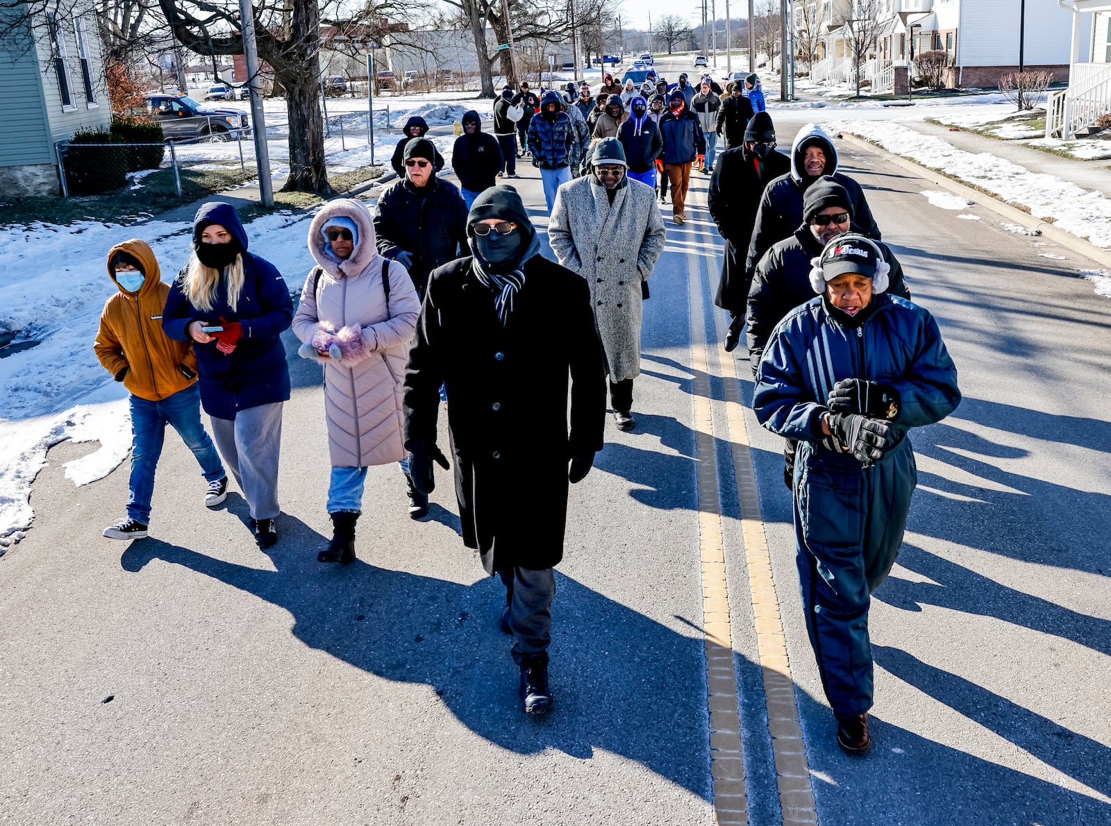 Rev. Victor Davis led a Martin Luther King Jr. Day march Monday, Jan. 20, 2025 in Hamilton. A large group marched from Booker T. Washington Community Center to High Street to Martin Luther King Jr. Blvd. and ended at St. Paul Miracle Center on S. Front Street for a service.  NICK GRAHAM / STAFF