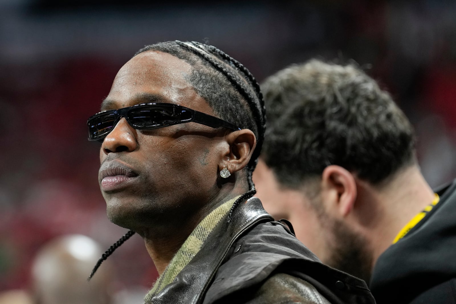 Rapper Travis Scott watches during warm ups before the College Football Playoff national championship game between Ohio State and Notre Dame Monday, Jan. 20, 2025, in Atlanta. (AP Photo/Brynn Anderson)