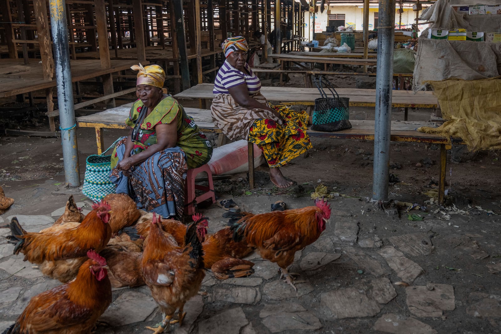 Women selling chickens wait for customers at the Virunga market in Goma, Democratic Republic of Congo, Thursday, Feb. 27, 2025, one month after Rwanda-backed M23 rebels captured the city. (AP Photo/Moses Sawasawa)