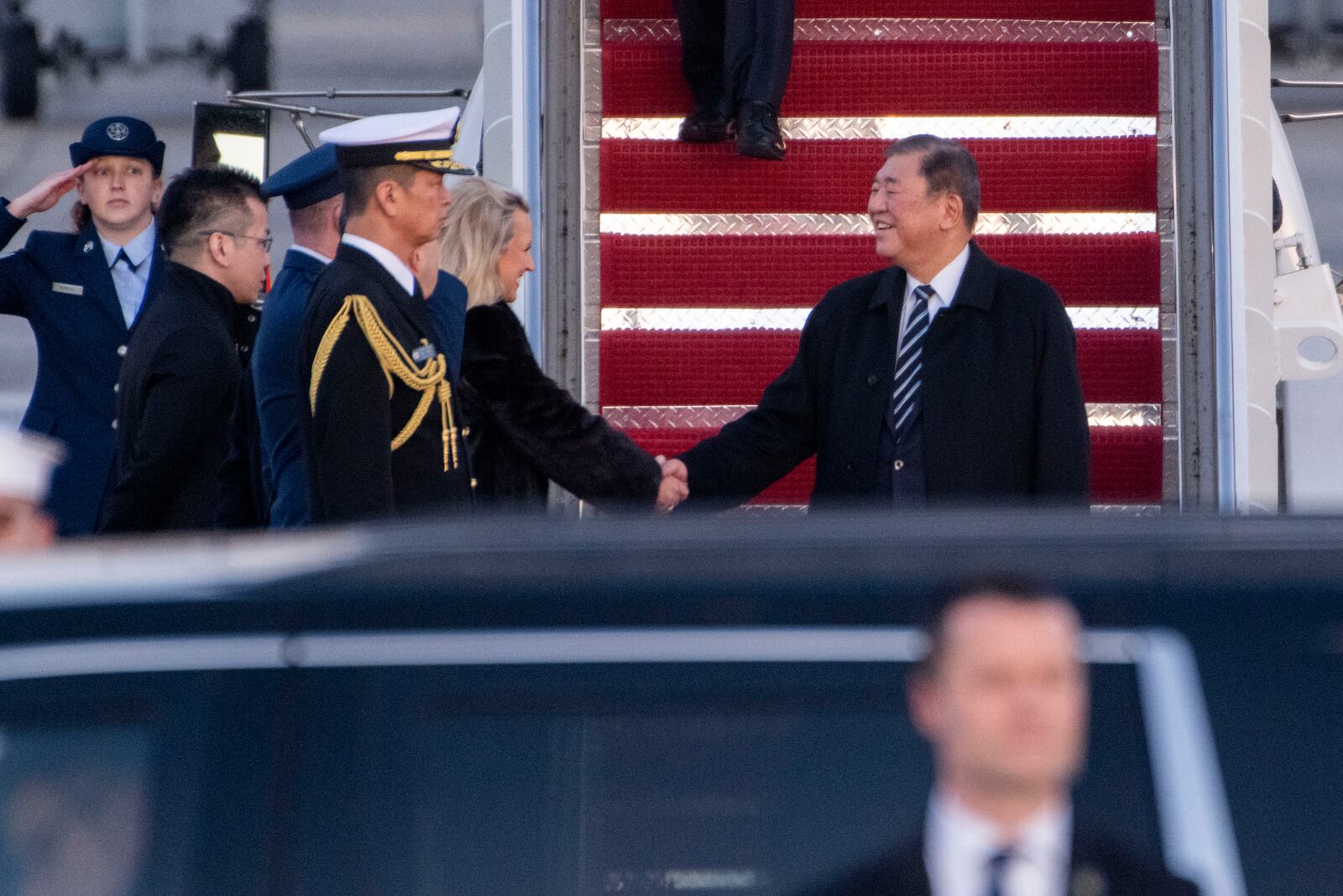 Japan's Prime Minister Shigeru Ishiba shakes hands as he is welcomed to Joint Base Andrews, Md., Thursday, Feb. 6, 2025. (AP Photo/Kevin Wolf)