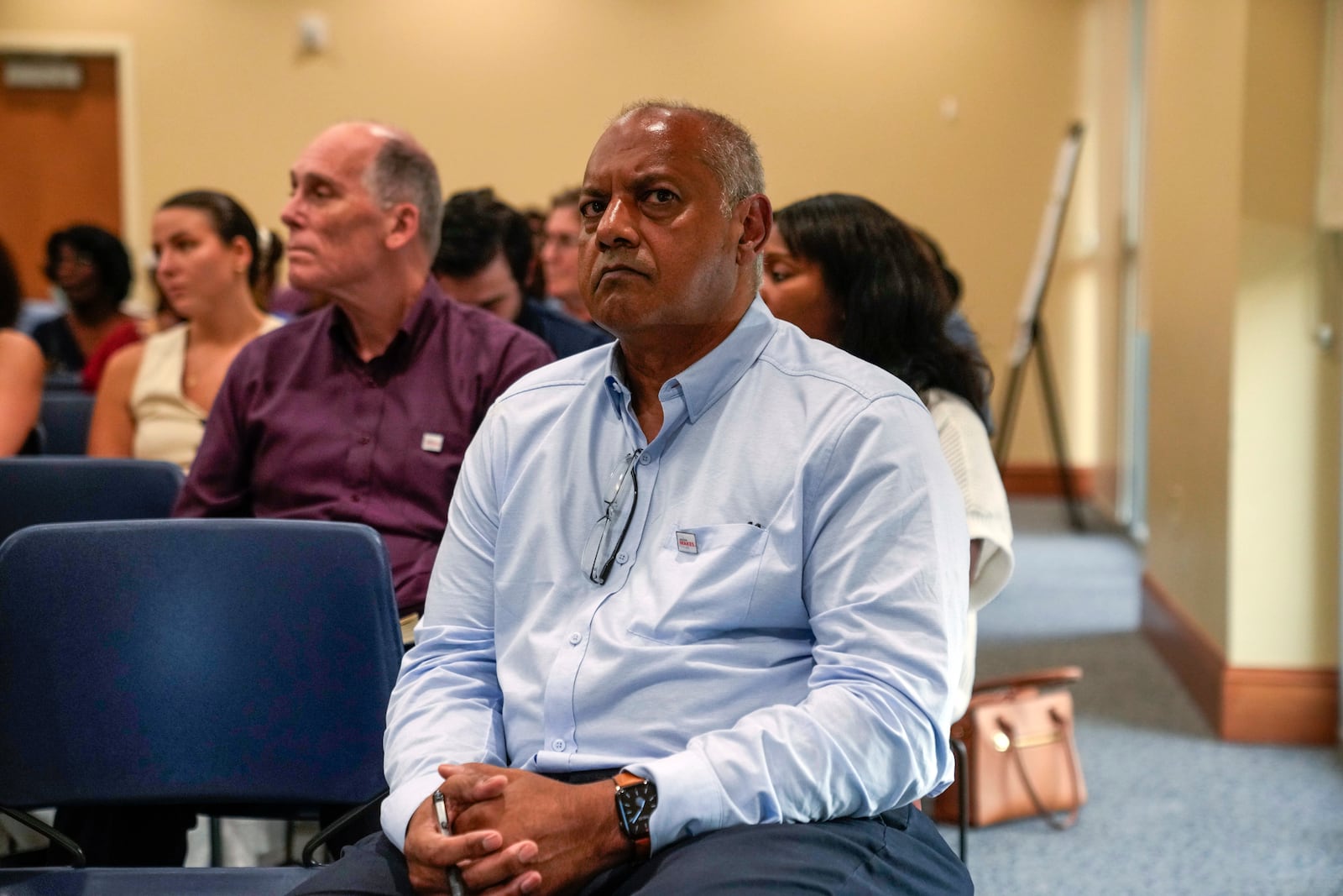 Ramesh Raman, project director for St. Charles Clean Fuels, listens as members of the public speak at a public hearing on the St. Charles Clean Fuels' coastal use permit application, Thursday, Aug. 22, 2024, in Destrehan, La. (AP Photo/Gerald Herbert)