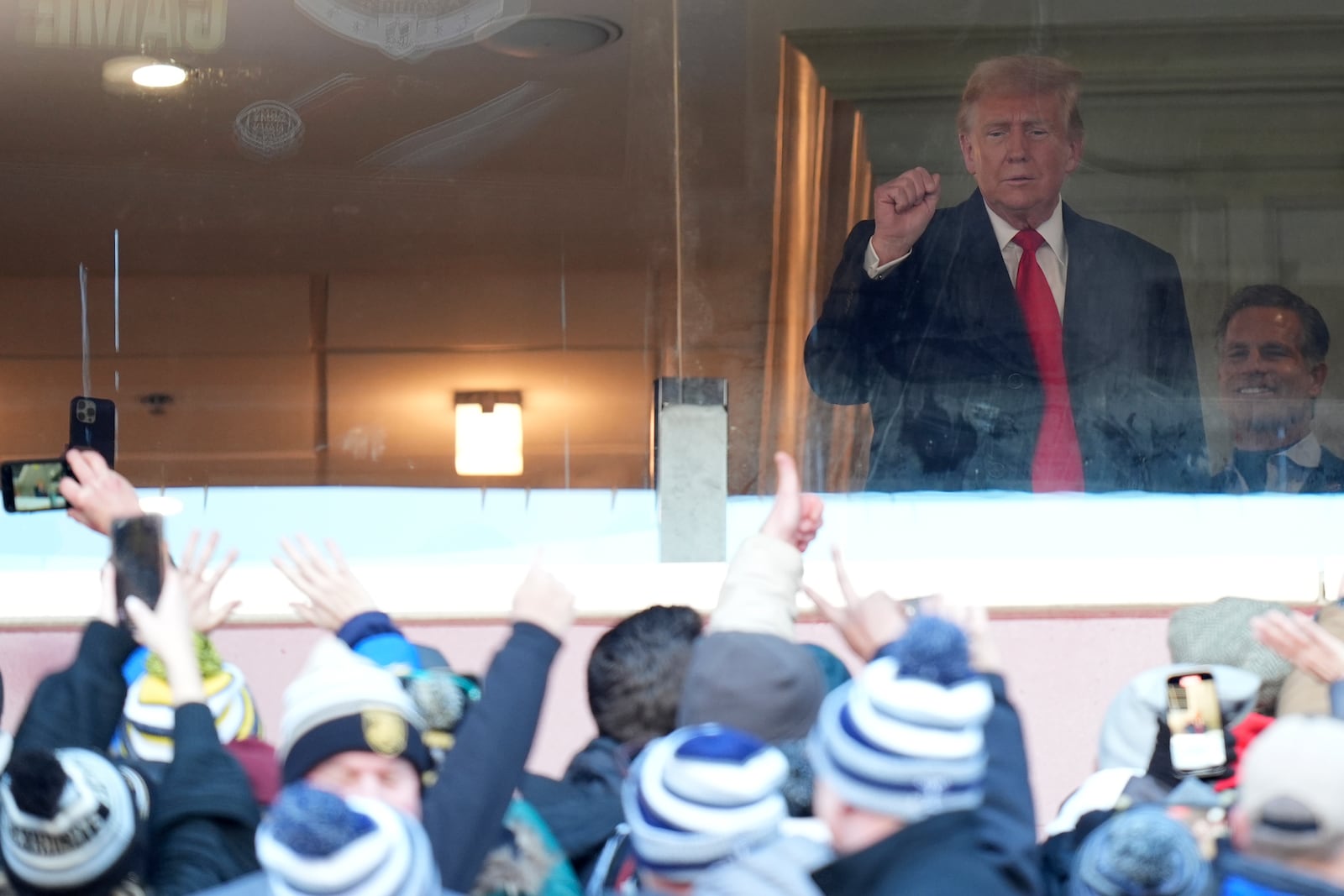 President-elect Donald Trump gestures to the crowd as he attends the NCAA college football game between Army and Navy at Northwest Stadium in Landover, Md., Saturday, Dec. 14, 2024. (AP Photo/Stephanie Scarbrough)