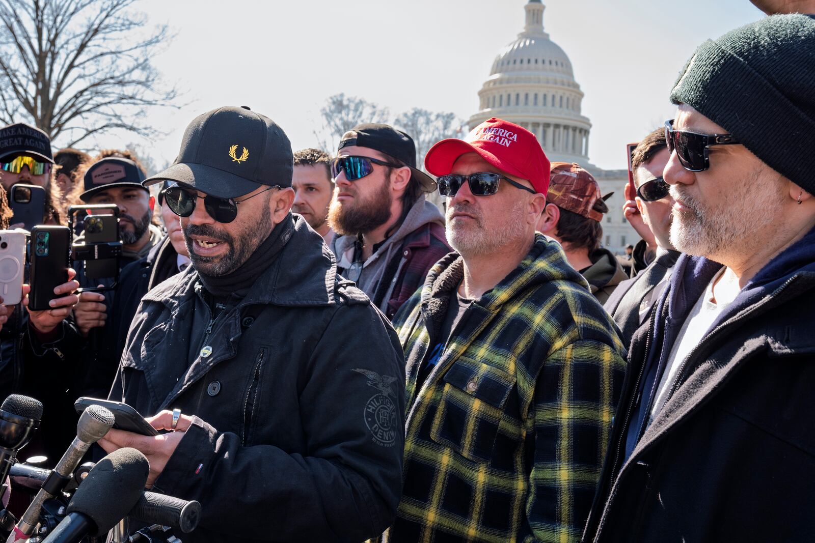 Former Proud Boys leader Enrique Tarrio, left, speaks at a news conference at the U.S. Capitol in Washington, Friday, Feb. 21, 2025, with Joseph Biggs, second from right. (AP Photo/J. Scott Applewhite)