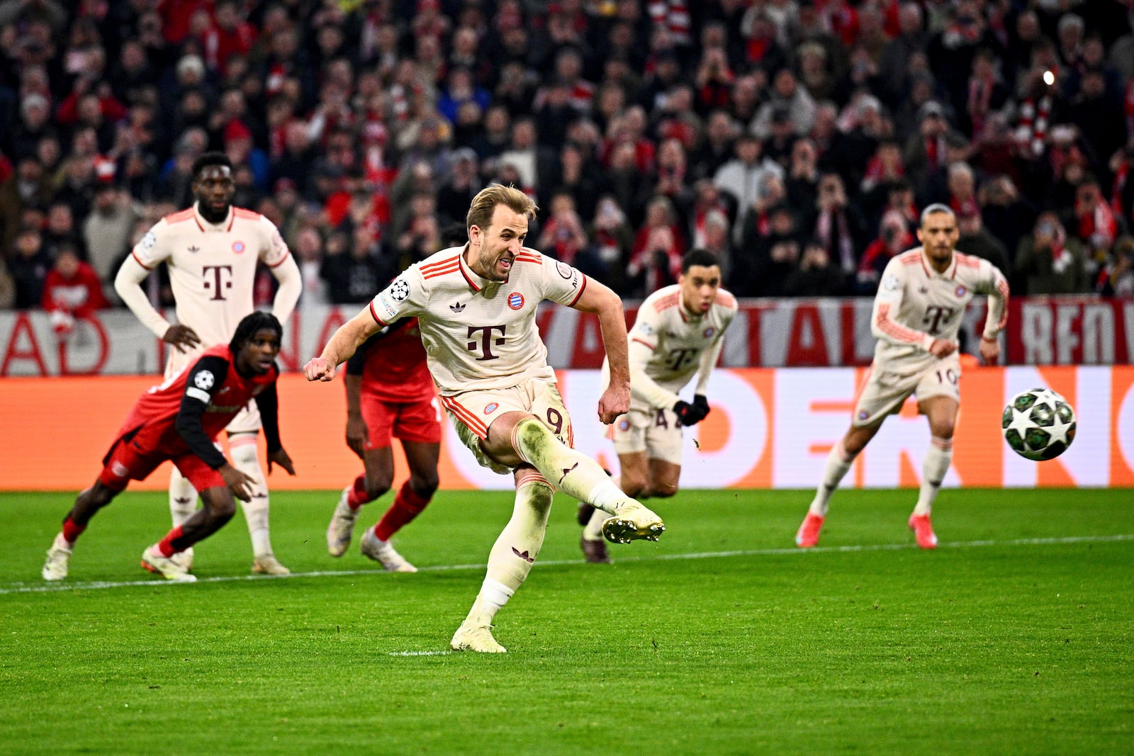 Munich's Harry Kane scores his side's third goal during the Champions League round of 16 first leg soccer match between FC Bayern Munich and Bayer 04 Leverkusen in Munich, Germany, Wednesday, March 5, 2025. (Tom Weller/dpa via AP)