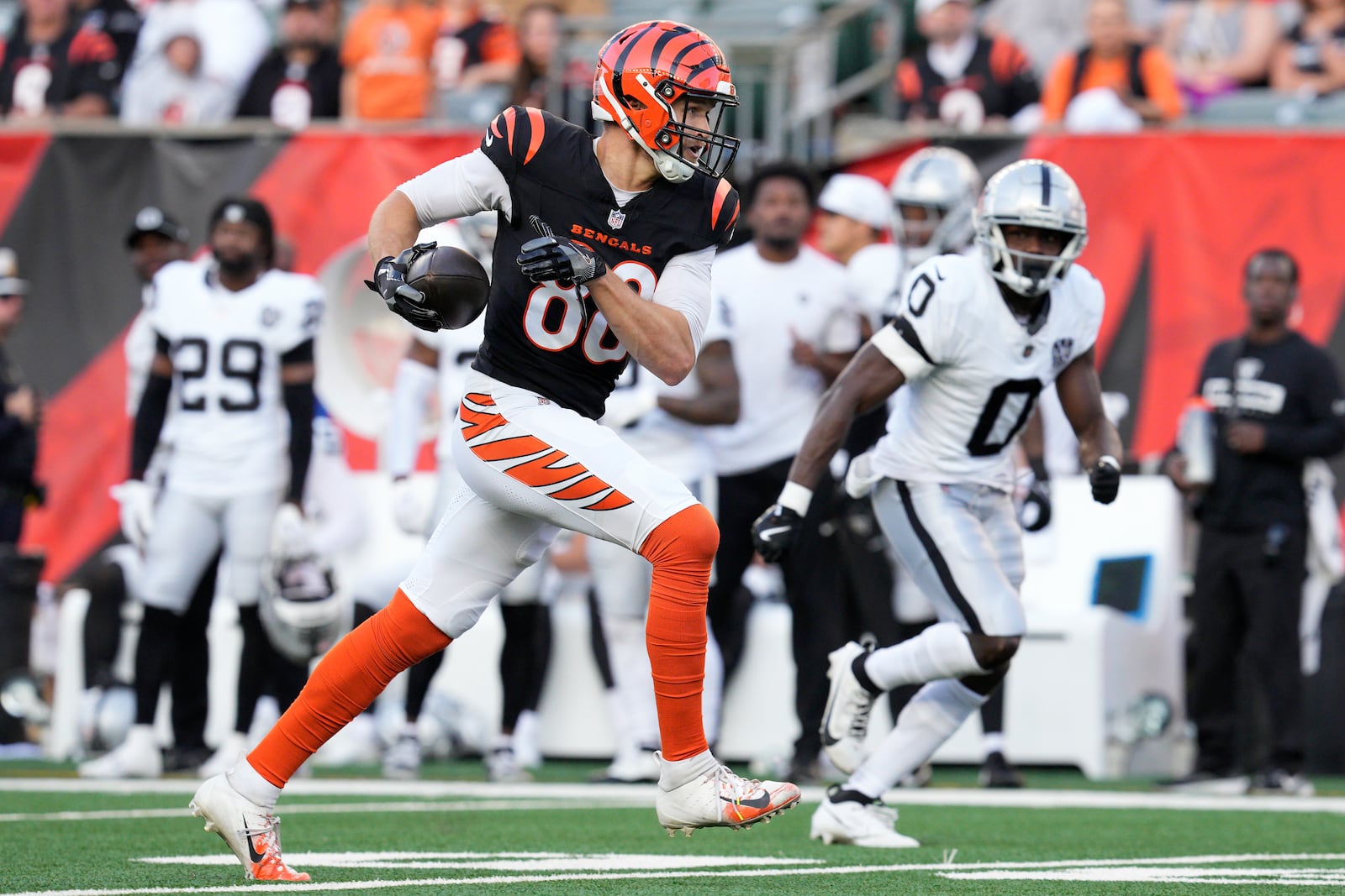 Cincinnati Bengals tight end Mike Gesicki, left, runs against Las Vegas Raiders cornerback Jakorian Bennett (0) during the second half of an NFL football game in Cincinnati, Sunday, Nov. 3, 2024. (AP Photo/Jeff Dean)