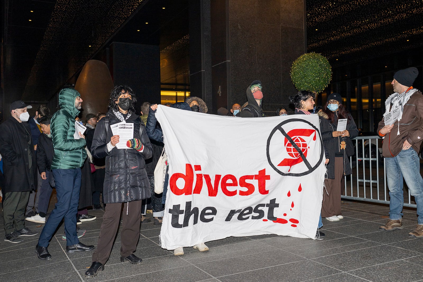 Demonstrators gather in front of a downtown Toronto hotel for the Giller Award ceremony, chanting "free Palestine" and holding banners, in Toronto, Monday, Nov. 18, 2024. (Eduardo Lima/The Canadian Press via AP)