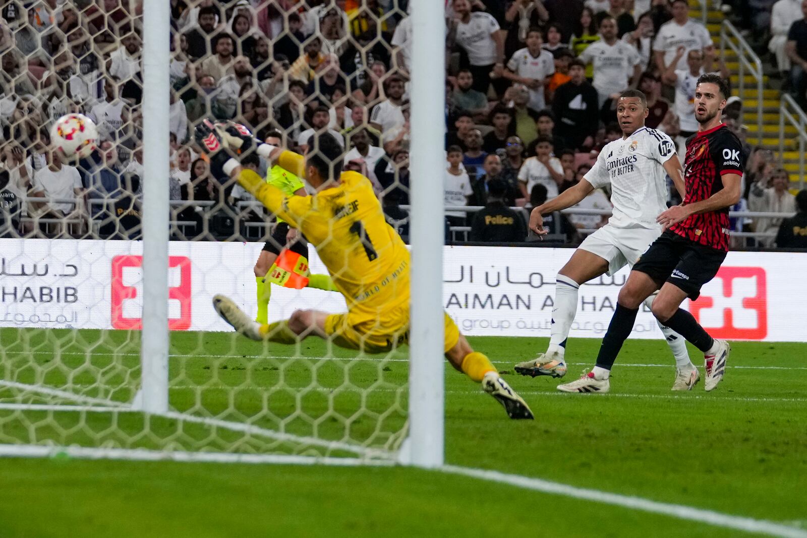 Mallorca's goalkeeper Dominik Greif saves Real Madrid's Kylian Mbappe's shot during the Spanish Super Cup semifinal soccer match between Real Madrid and Mallorca at the King Abdullah Stadium in Jeddah, Saudi Arabia, Thursday, Jan. 9, 2025. (AP Photo/Altaf Qadri)