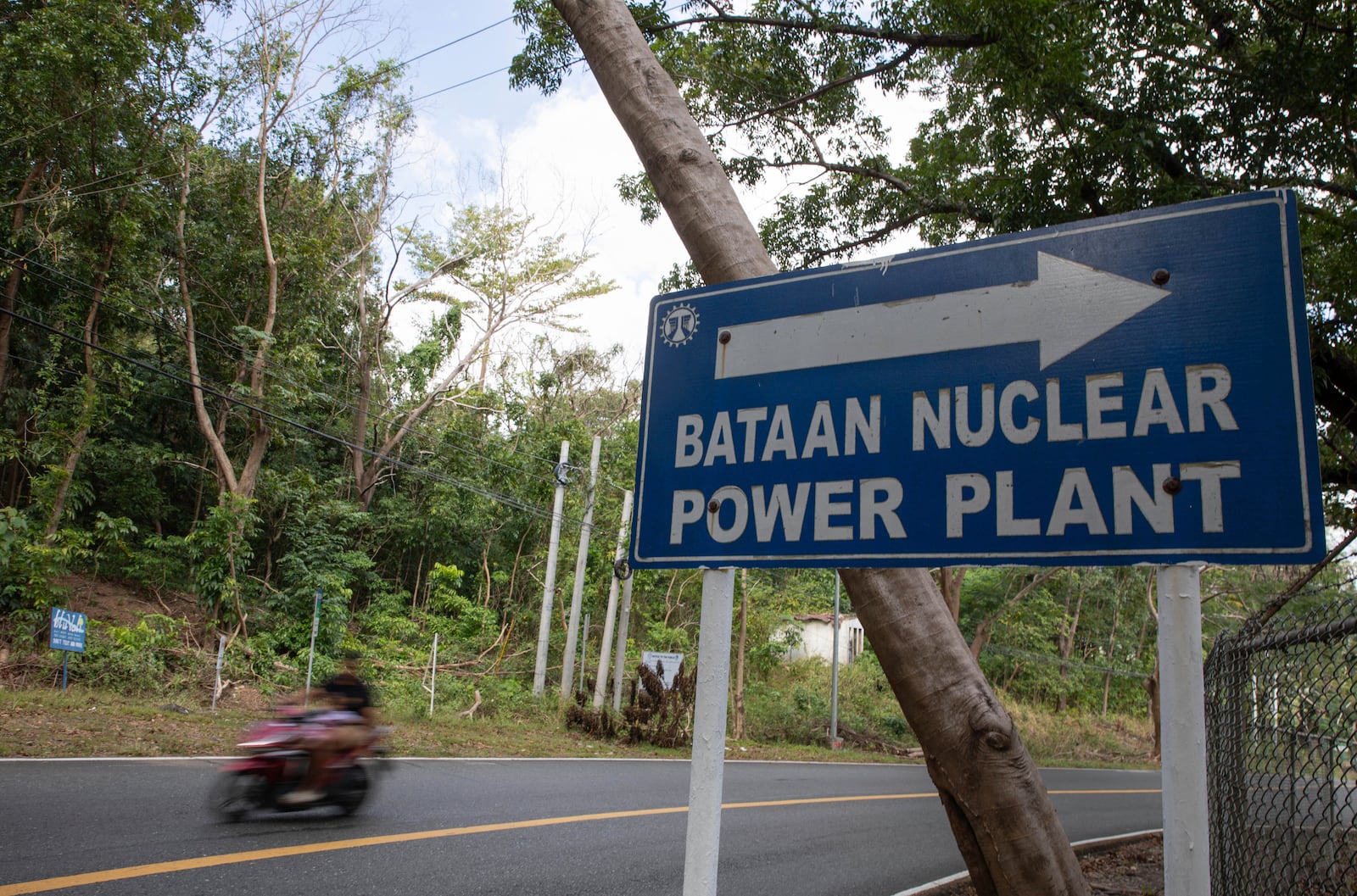 A motorist drives past a signage for the Bataan Nuclear Power Plant in the Philippines on Sunday, Jan. 19, 2025. (AP Photo/Anton L. Delgado)