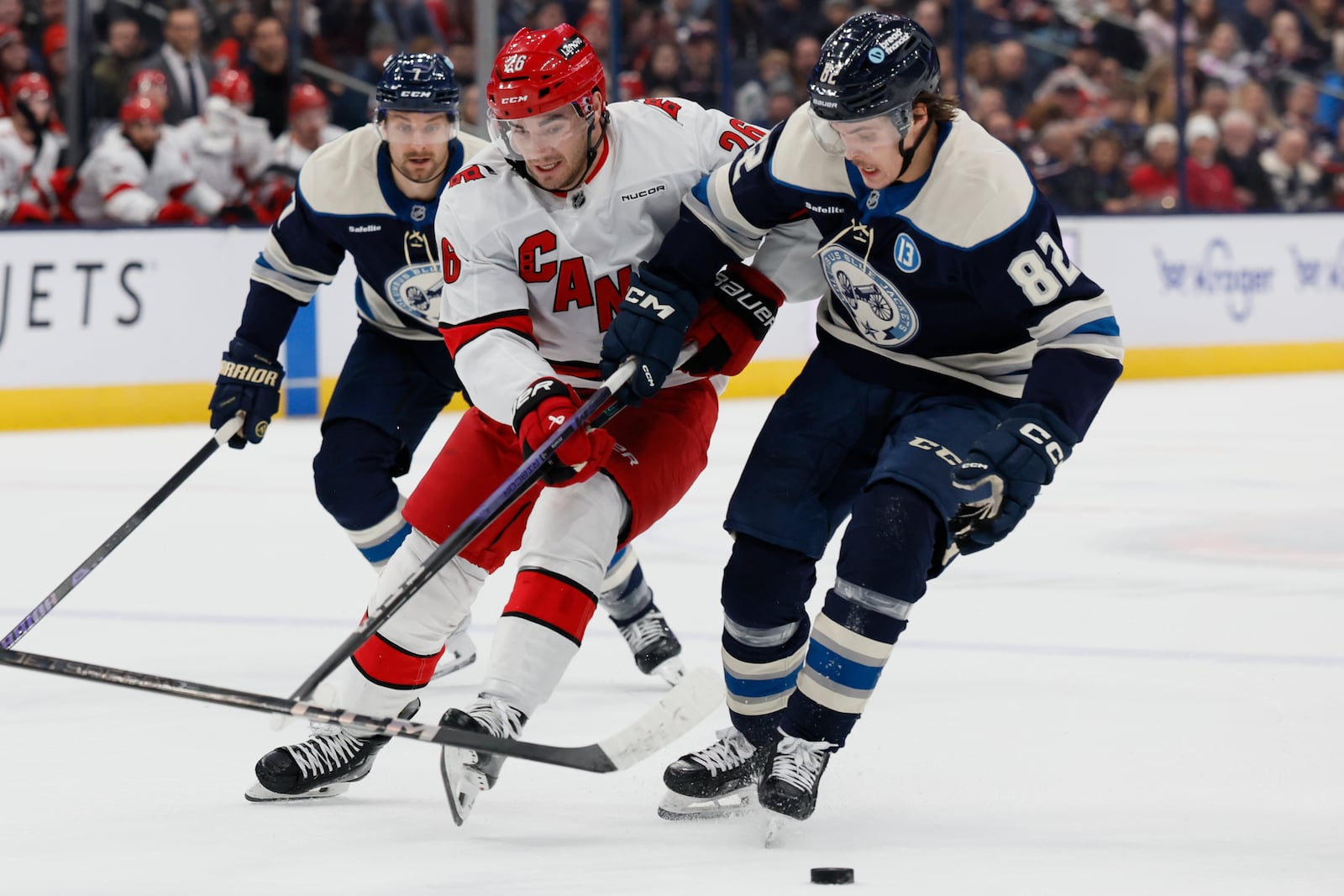 Carolina Hurricanes' Sean Walker, left, and Columbus Blue Jackets' Mikael Pyyhtia chase the puck during the first period of an NHL hockey game Tuesday, Dec. 31, 2024, in Columbus, Ohio. (AP Photo/Jay LaPrete)