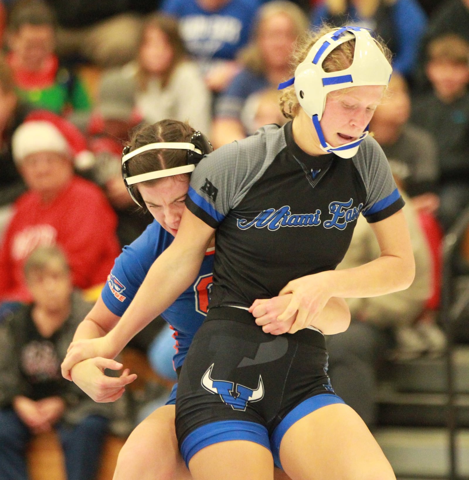 Emily Adkins of Miami East (front) tries to escape from Alyssa Wallace. Olentangy Orange defeated host Miami East 48-36 in the Ohio’s first girls high school dual wrestling match on Wednesday, Dec. 18, 2019. MARC PENDLETON / STAFF