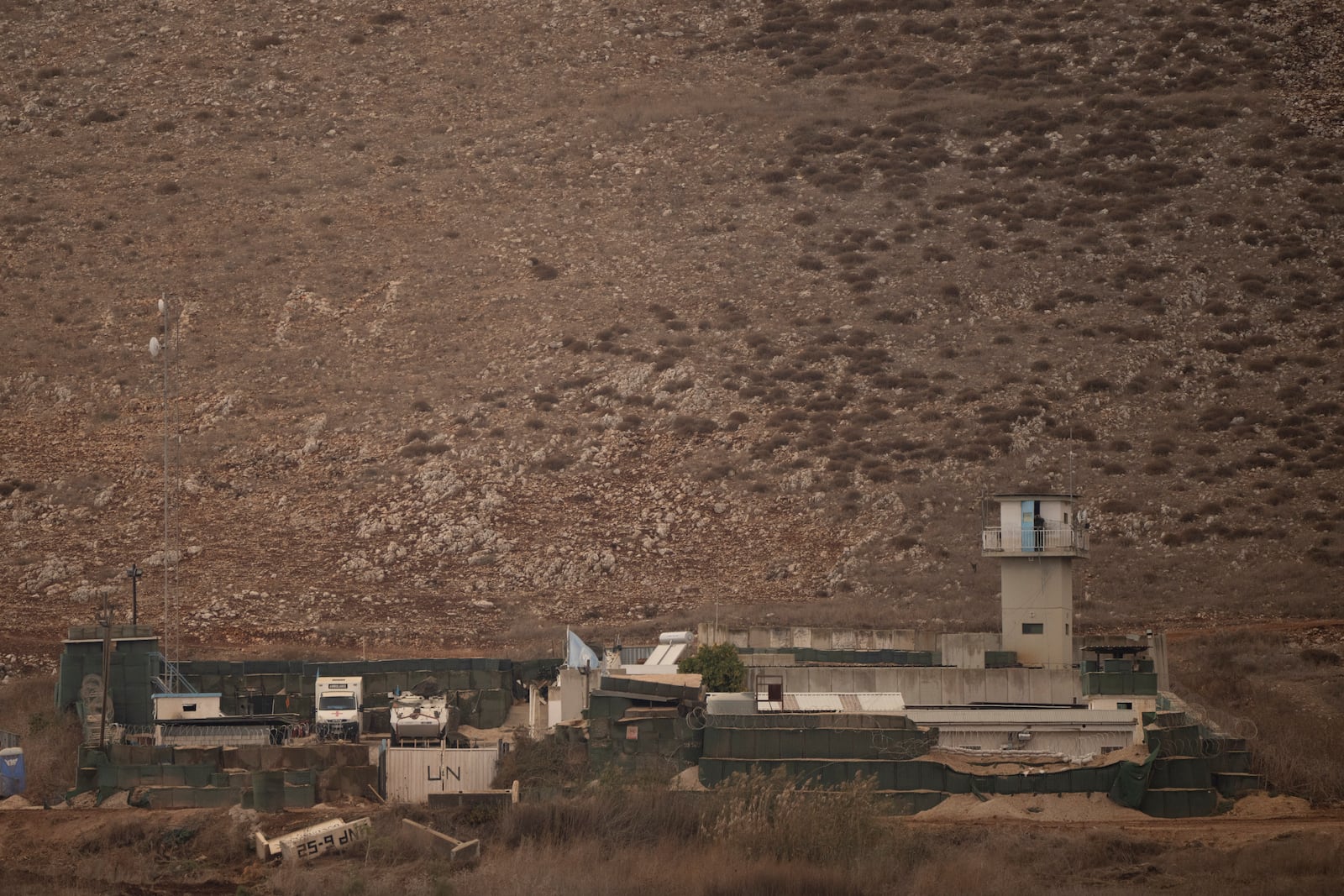 An UN soldier stands on the top of a tower at a base of the United Nations peacekeeping forces in Lebanon (UNIFIL) at the Israeli-Lebanese border as seen from northern Israel, Tuesday, Nov. 19, 2024. (AP Photo/Leo Correa)