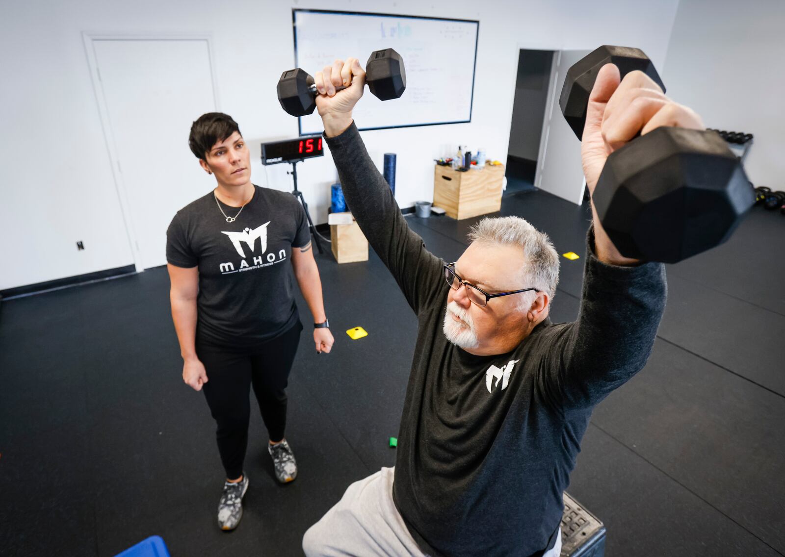 Bryan Watkins works with Mimi Mahon at Mahon Strength and Fitness on Brookwood Ave. in Hamilton Jan. 18, 2022. Mahon, donated a kidney to an exchange program when her mom needed a kidney. Watkins is trying to get in better shape with increase mobility while he waits for kidney tansplant. NICK GRAHAM / STAFF