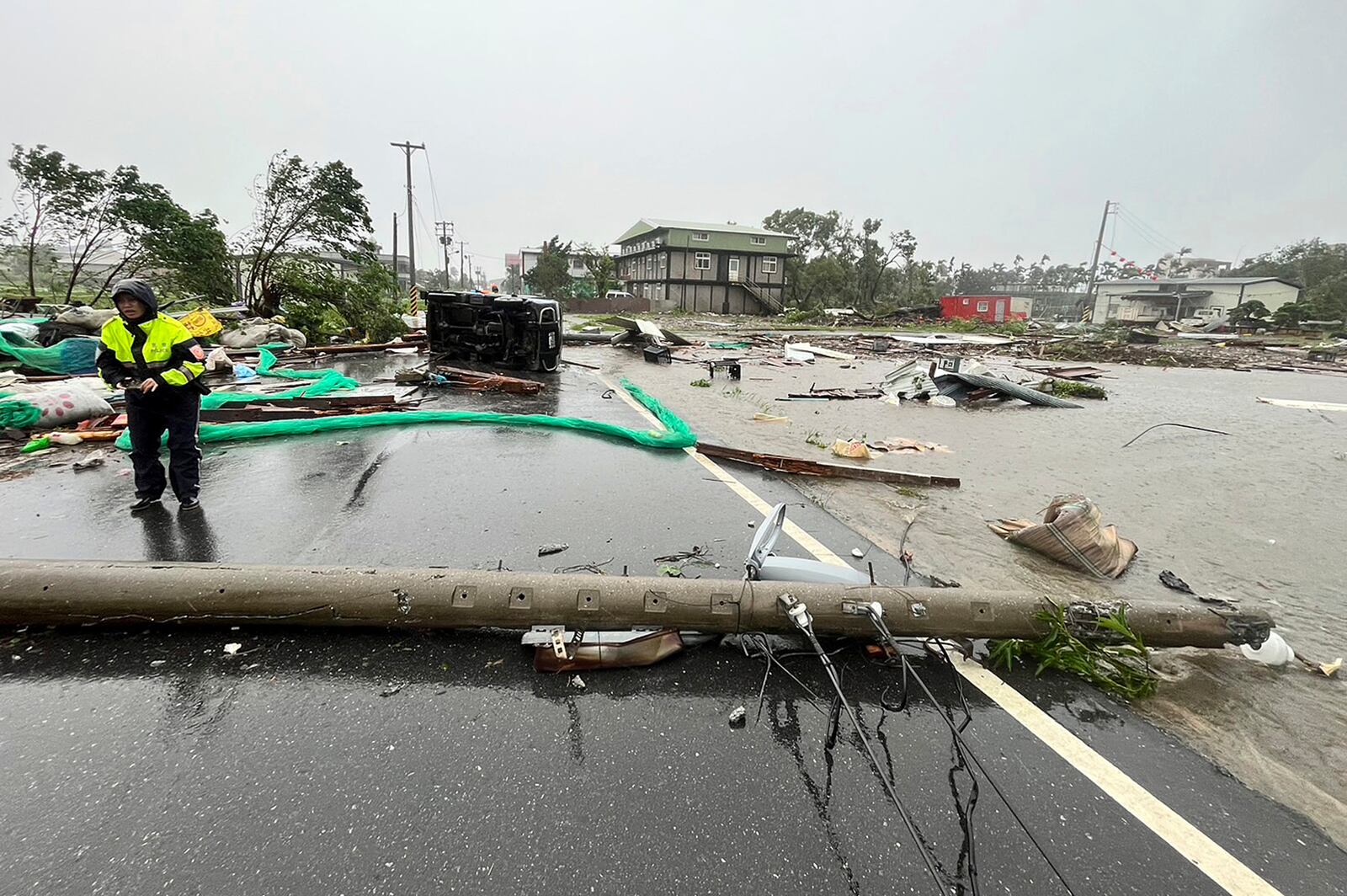 In this photo released by Hualien County Fire Department, police check an area destroyed by the wind from Typhoon Kong-rey in Hualien County, eastern Taiwan, Thursday, Oct. 31, 2024. (AP Photo/Hualien County Fire Department)