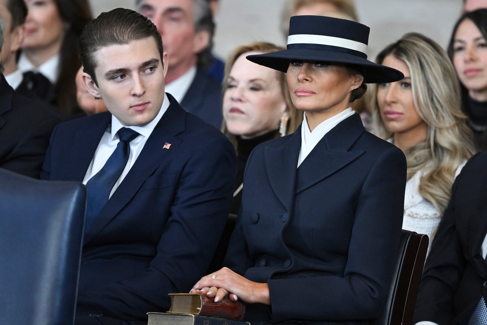 Barron Trump and first lady Melania Trump listen as President Donald Trump delivers remarks after being sworn in during the 60th Presidential Inauguration in the Rotunda of the U.S. Capitol in Washington, Monday, Jan. 20, 2025. (Saul Loeb/Pool photo via AP)