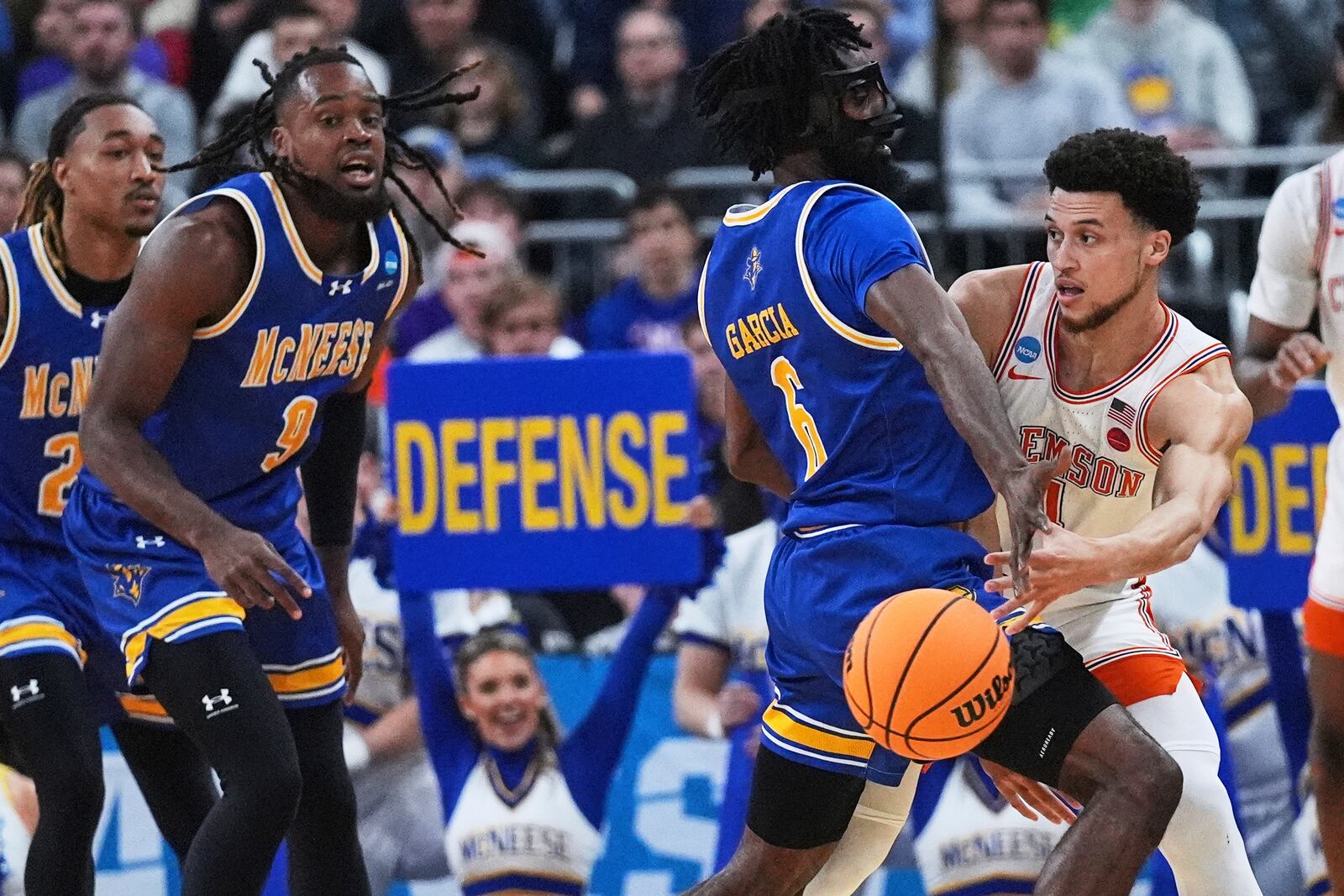 Clemson guard Chase Hunter, right, passes while covered by McNeese State guard Javohn Garcia (6) during the first half in the first round of the NCAA college basketball tournament, Thursday, March 20, 2025, in Providence, R.I. (AP Photo/Charles Krupa)