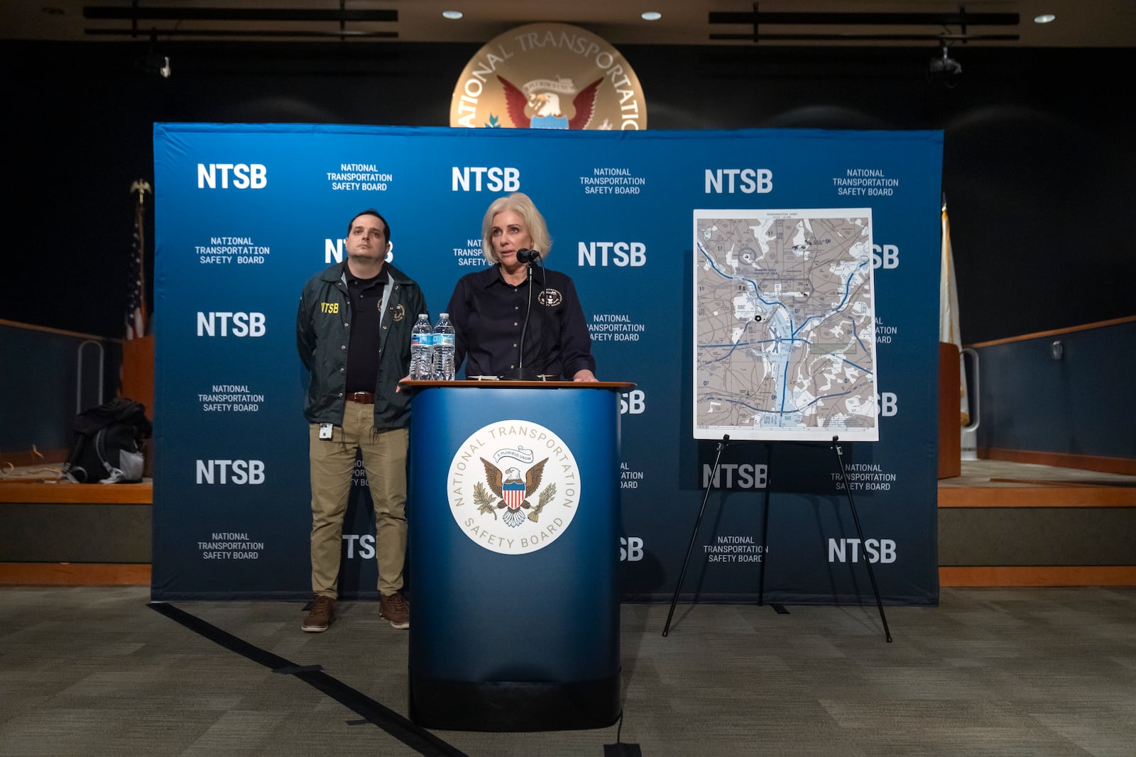 National Transportation Safety Board Chair Jennifer Homendy speaks as NTSB investigator Sean Payne listens during a news conference Friday, Feb. 14, 2025, in Washington. (AP Photo/Mark Schiefelbein)