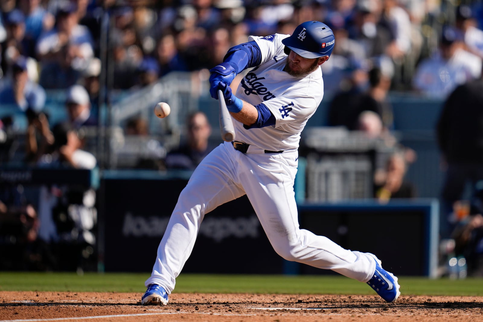 Los Angeles Dodgers' Max Muncy connects for a solo home run against the New York Mets during the fifth inning in Game 2 of a baseball NL Championship Series, Monday, Oct. 14, 2024, in Los Angeles. (AP Photo/Gregory Bull)