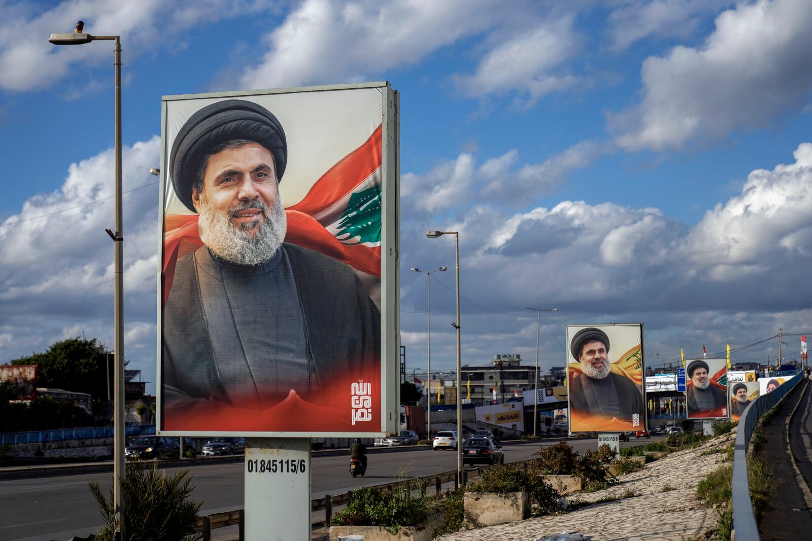 People drive past billboards with a picture of the late Lebanon's Hezbollah leader Sayyed Hashem Safieddine displayed on Beirut airport highway, Lebanon, Friday, Feb. 21, 2025. (AP Photo/Bilal Hussein)