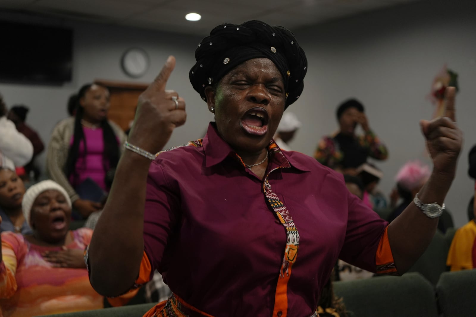 Suzette Cleophat worships with fellow congregants at the First Haitian Evangelical Church of Springfield, Sunday, January 26, 2025, in Springfield, Ohio. (AP Photo/Luis Andres Henao)