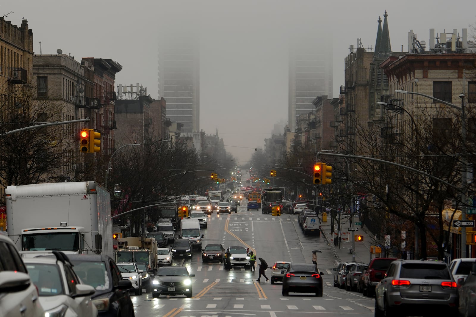 Cars drive through rain, Thursday, Feb. 6, 2025, in New York. (AP Photo/Julia Demaree Nikhinson)