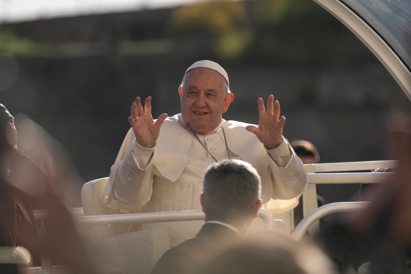 Pope Francis gestures near the Notre Dame of the Assumption cathedral Sunday, Dec. 15, 2024 in Ajaccio, Corsica island. Pope Francis' one-day visit to the French island of Corsica puts a dual focus on the Mediterranean, highlighting local traditions of popular piety on the one hand and migrant deaths and wars on the other. (AP Photo/Thibault Camus)