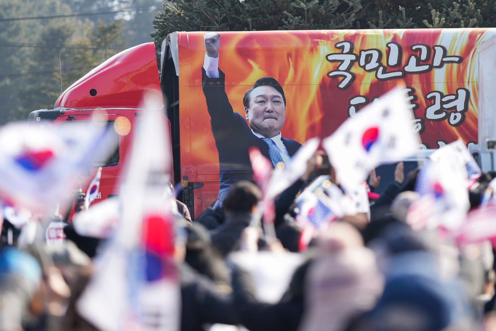 A picture of impeached South Korean President Yoon Suk Yeol is seen on the vehicle during a rally to oppose his impeachment outside of a detention center in Uiwang, South Korea, Friday, Jan. 17, 2025. (AP Photo/Lee Jin-man)