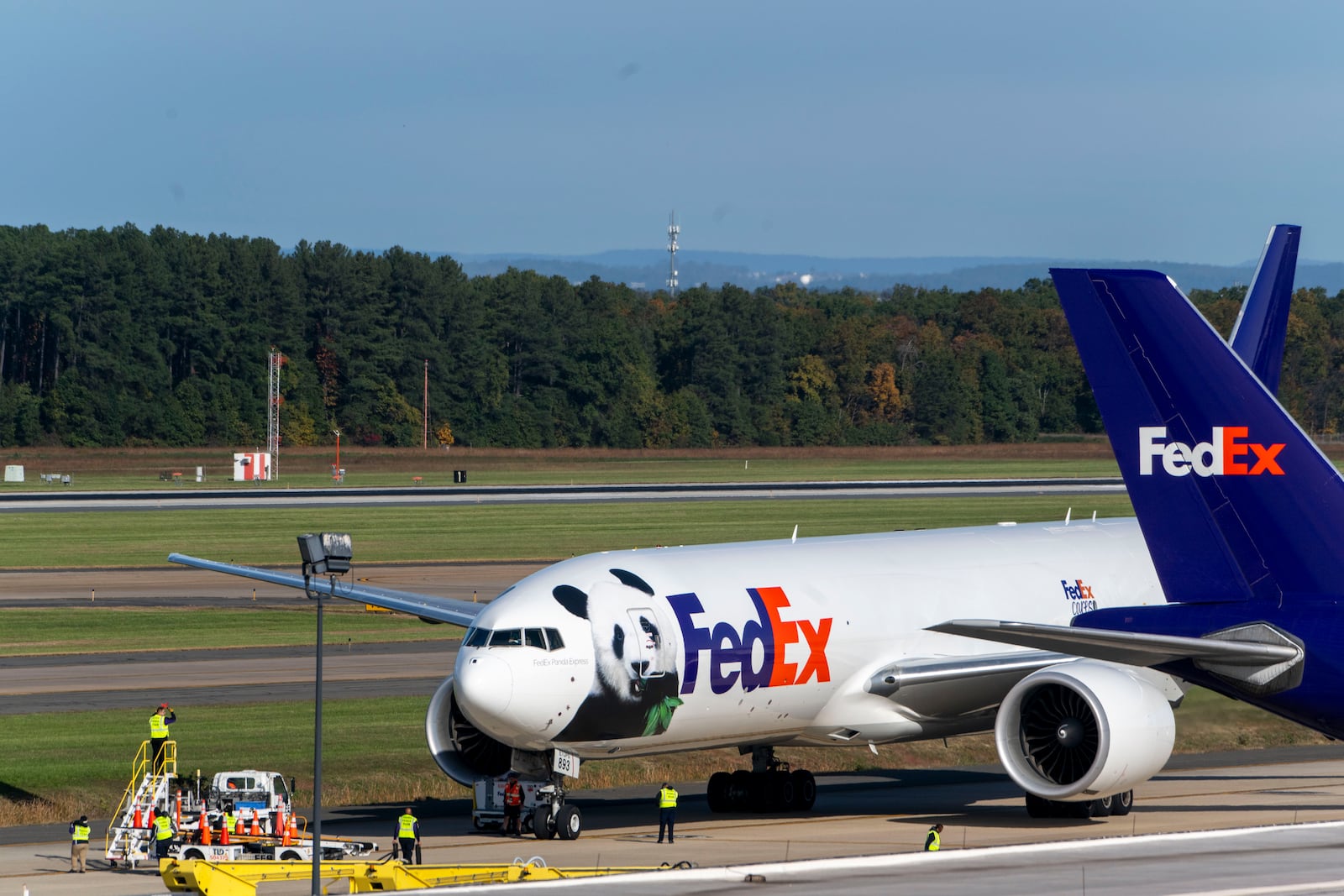 A FedEx cargo plane arrives at Dulles International Airport carrying giant pandas from China on Tuesday, Oct. 15, 2024 in Sterling, Va. (AP Photo/Kevin Wolf)