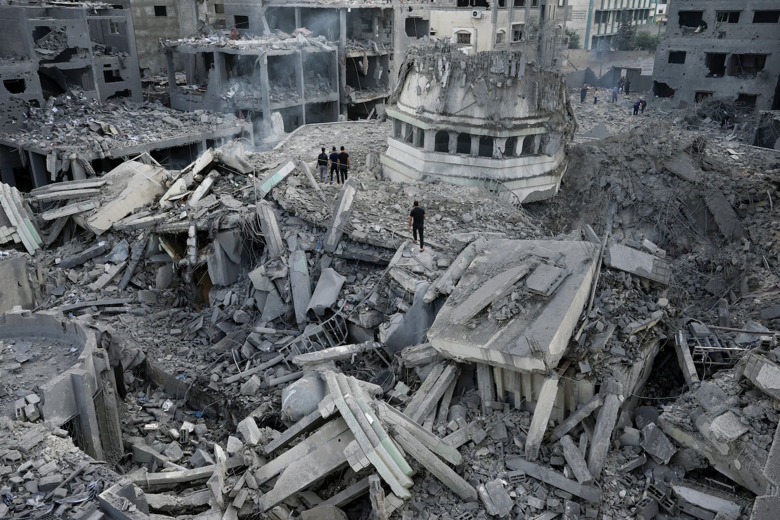 FILE - Palestinians inspect the rubble of the Yassin Mosque destroyed after it was hit by an Israeli airstrike at Shati refugee camp in Gaza City, on Oct. 9, 2023. (AP Photo/Adel Hana, File)