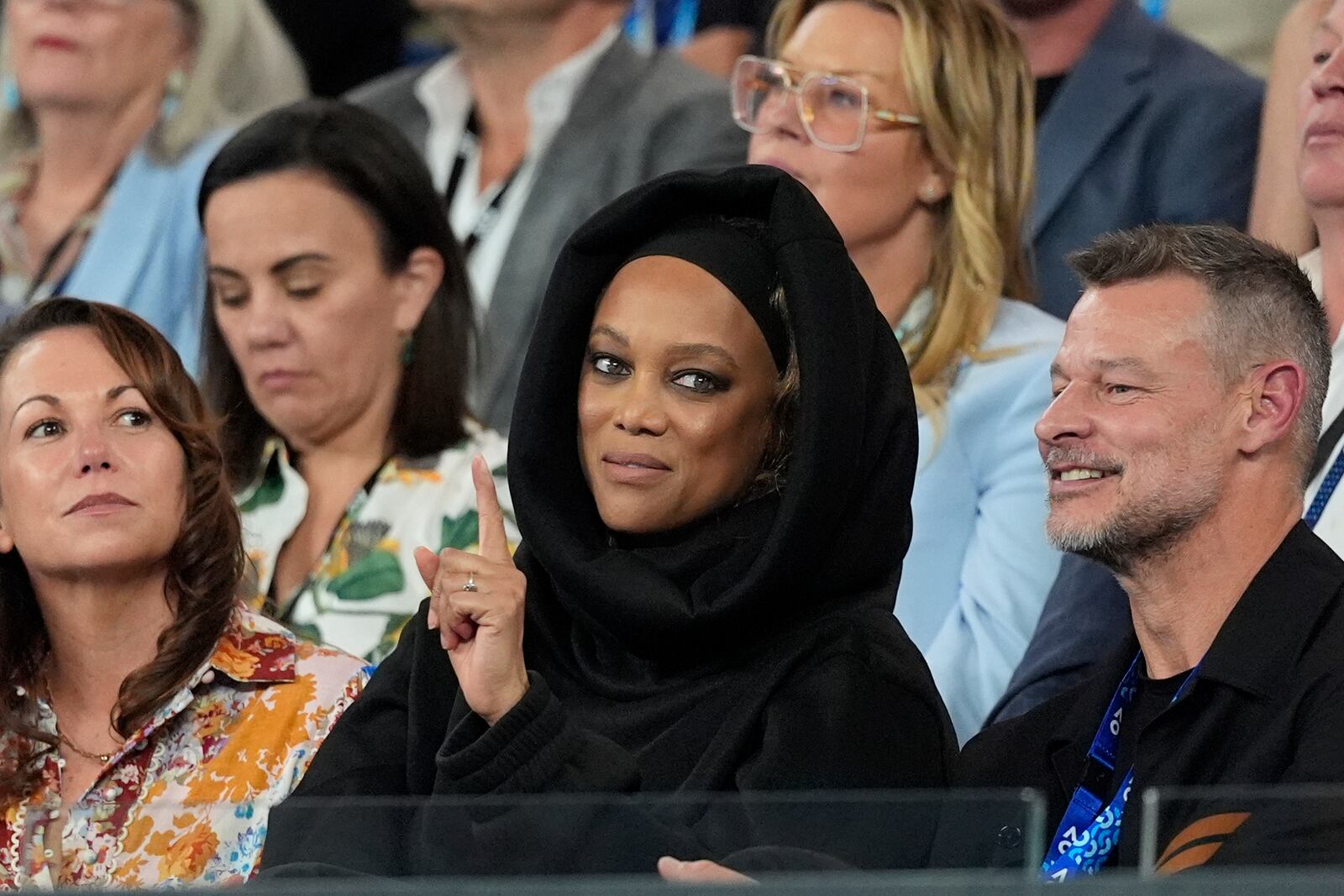 American model and TV presenter Tyra Banks gestures as she watches Paula Badosa of Spain and Aryna Sabalenka of Belarus during their semifinal match at the Australian Open tennis championship in Melbourne, Australia, Thursday, Jan. 23, 2025. (AP Photo/Asanka Brendon Ratnayake)