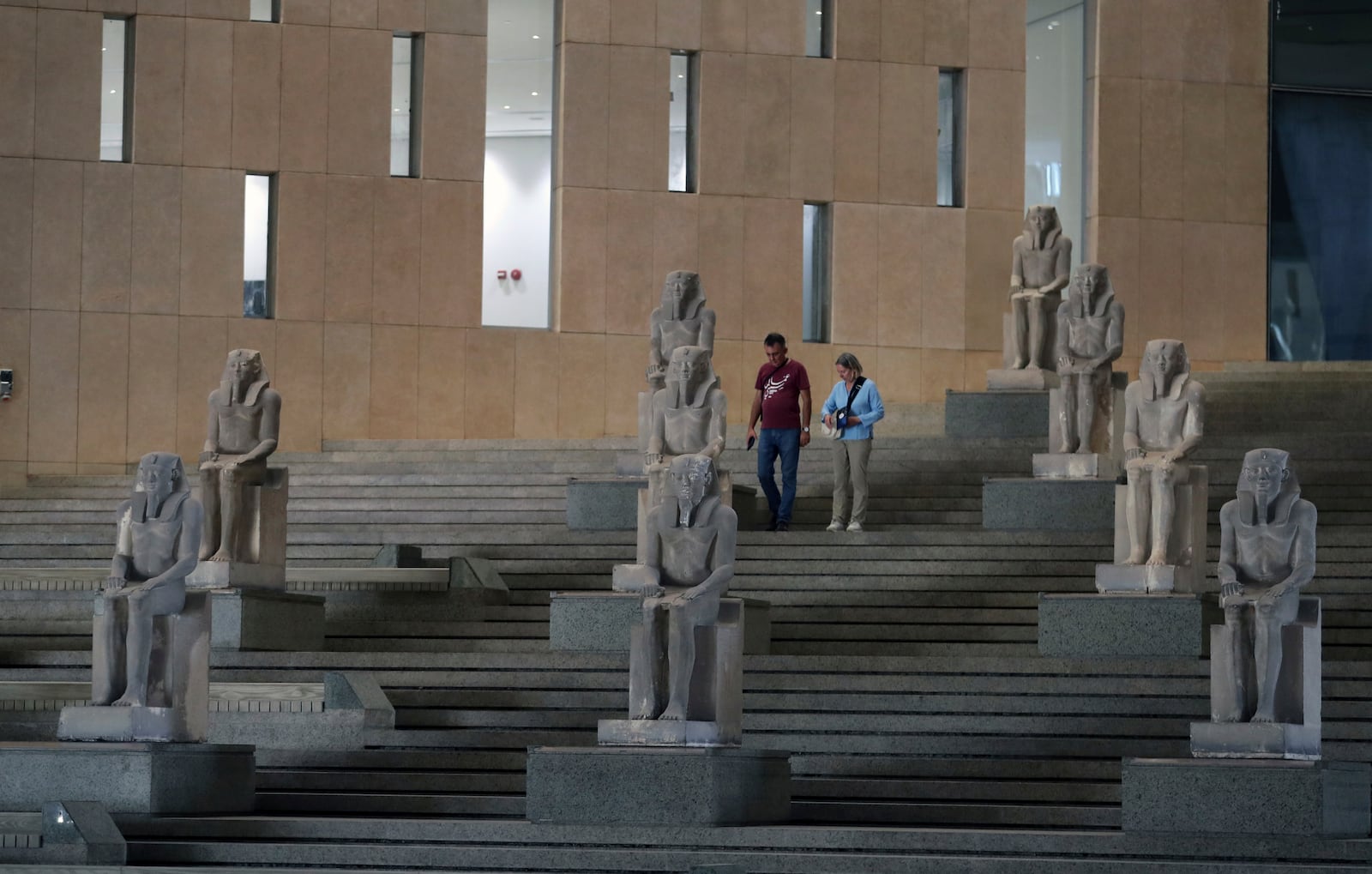 Visitors walk past ancient Egyptian statues along the Grand Staircase at the Grand Egyptian Museum in Giza, Egypt, Tuesday, Oct.15, 2024. (AP Photo/Khaled Elfiqi)