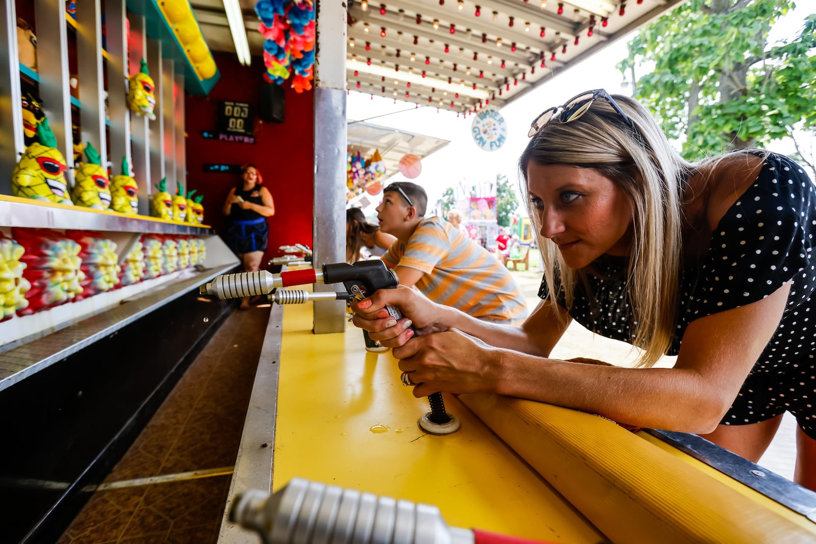 Amanda Lankford tries to beat her son, Sylas, 10, and Alayna, 13, at the squirt gun game at the Butler County Fair Wednesday, July 28, 2021, in Hamilton. NICK GRAHAM / STAFF