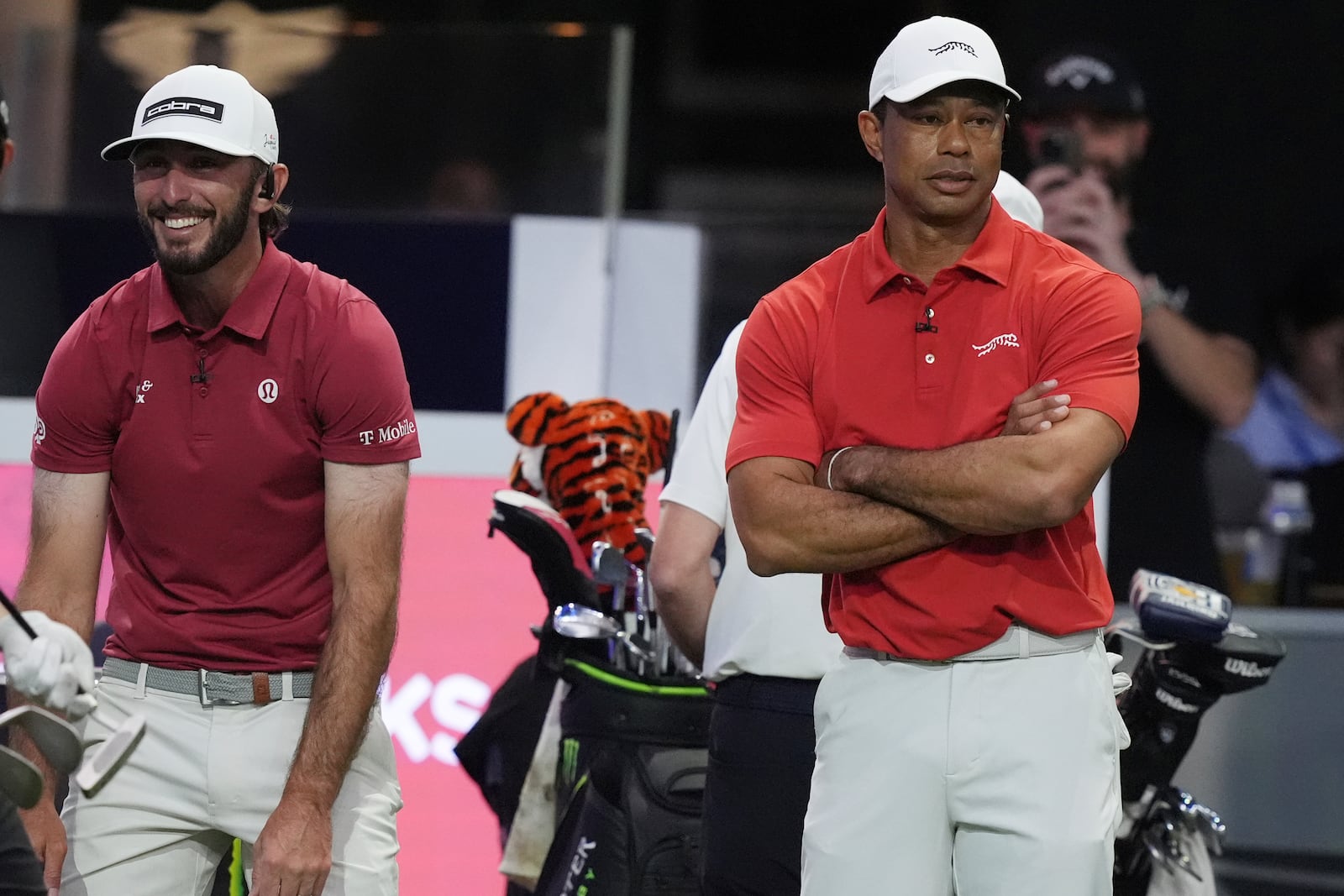 Tiger Woods and Max Homa of the Jupiter Links Golf Club react as they fall behind the Los Angeles Golf Club, Tuesday, Jan. 14, 2025, in Palm Beach Gardens, Fla. (AP Photo/Marta Lavandier)