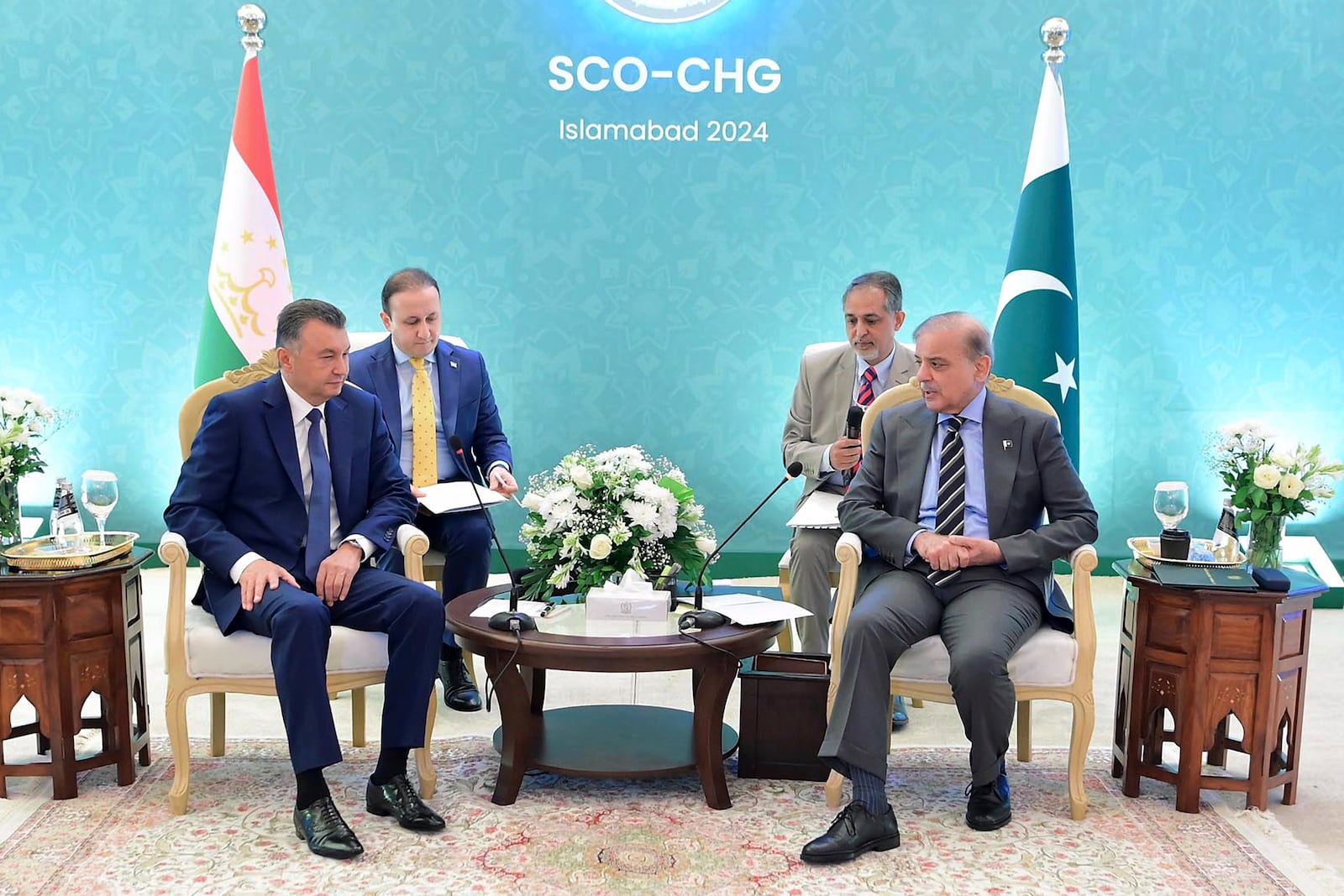 In this photo released by the Press Information Department, Tajikistan's Prime Minister Qohir Rasulzoda, front left, listens to his Pakistani counterpart Shehbad Sharif ahead of an Asian security group meeting in Islamabad, Pakistan, Tuesday, Oct. 15, 2024. (Press Information Department via AP)