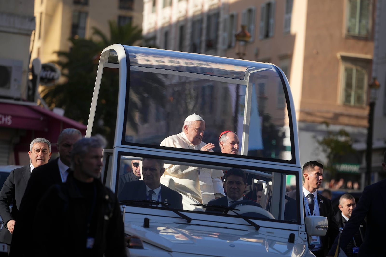 Pope Francis greets faithful after praying in front of the statue of the Virgin Mary in Ajaccio on the occasion of his one-day visit in the French island of Corsica, Sunday, Dec. 15, 2024. (AP Photo/Alessandra Tarantino)