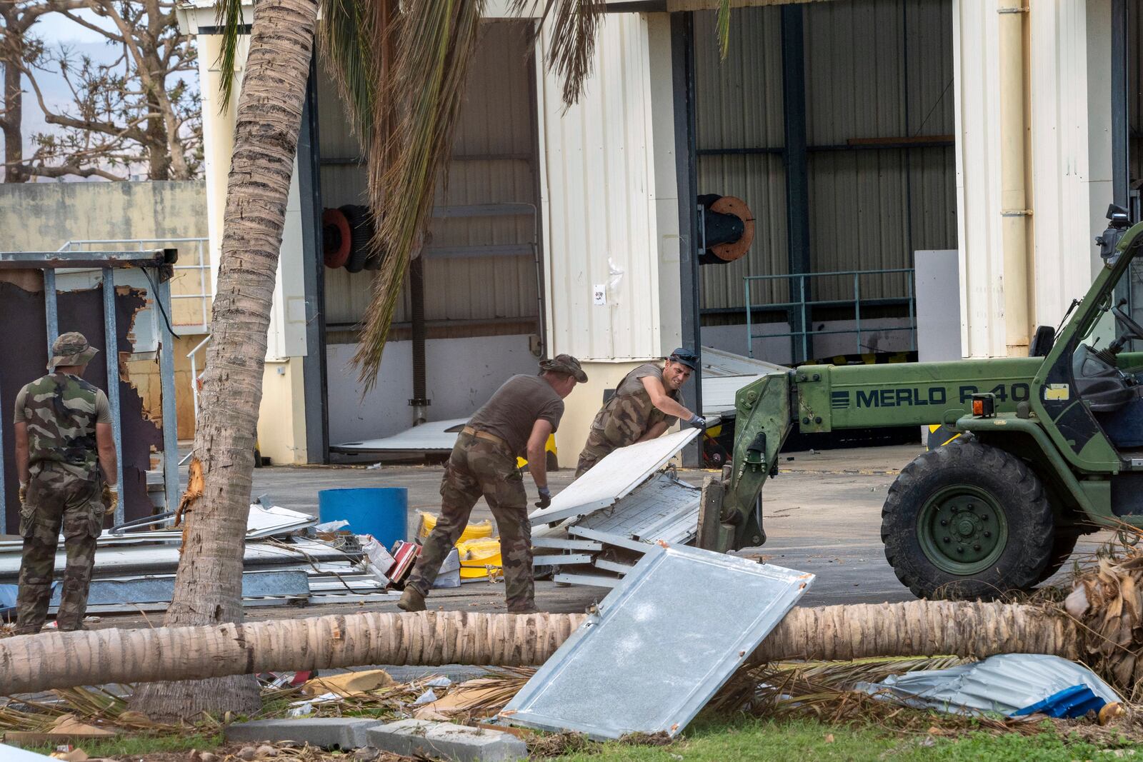 This photo provided by the French Army shows soldiers clearing a road in the Indian Ocean French territory of Mayotte, Wednesday Dec.18, 2024, as the cyclone on Saturday was the deadliest storm to strike the territory in nearly a century. (D Piatacrrea, Etat Major des Armees/Legion Etrangere via AP)