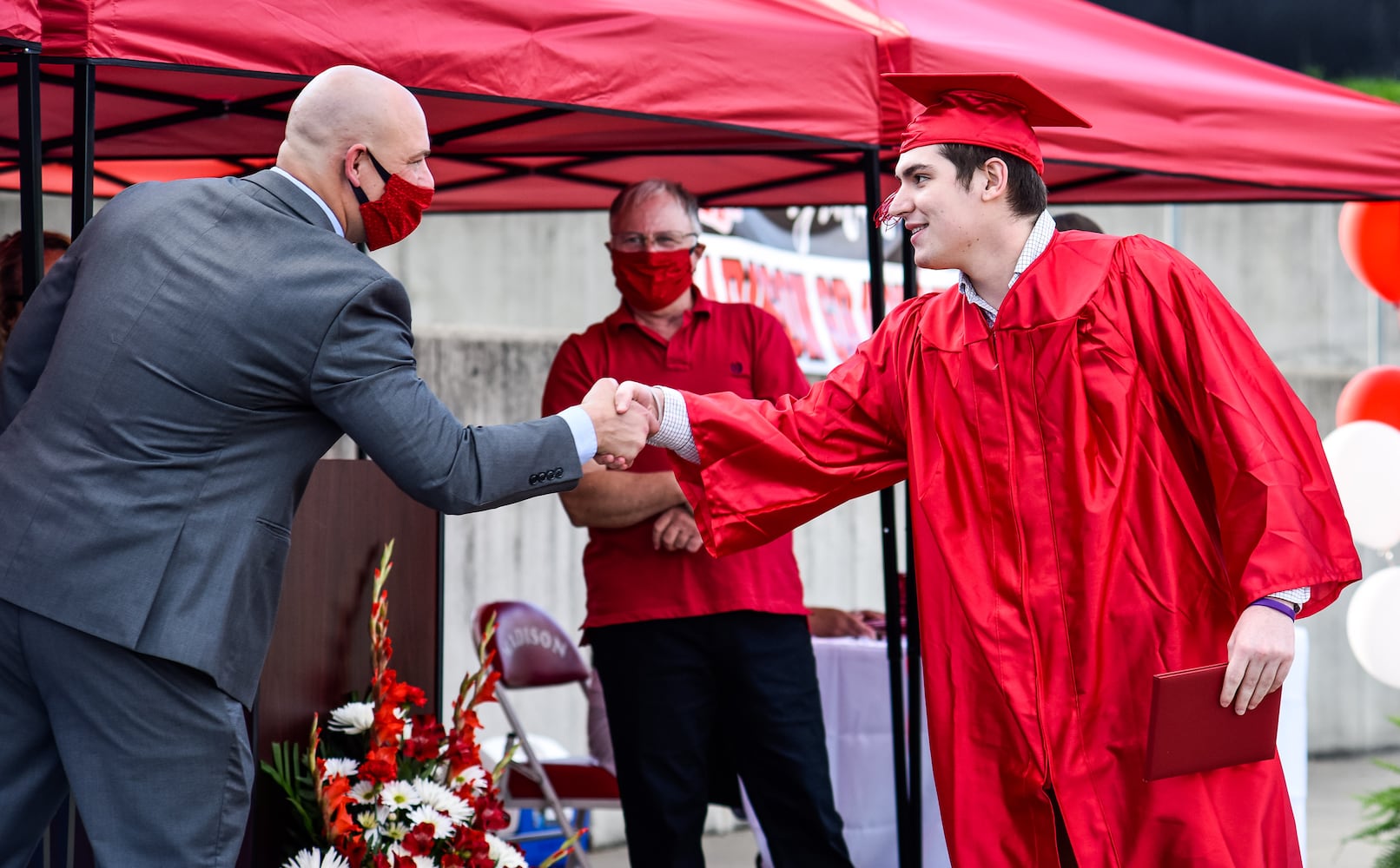 Madison High School drive-thru graduation ceremony at Land of Illusion