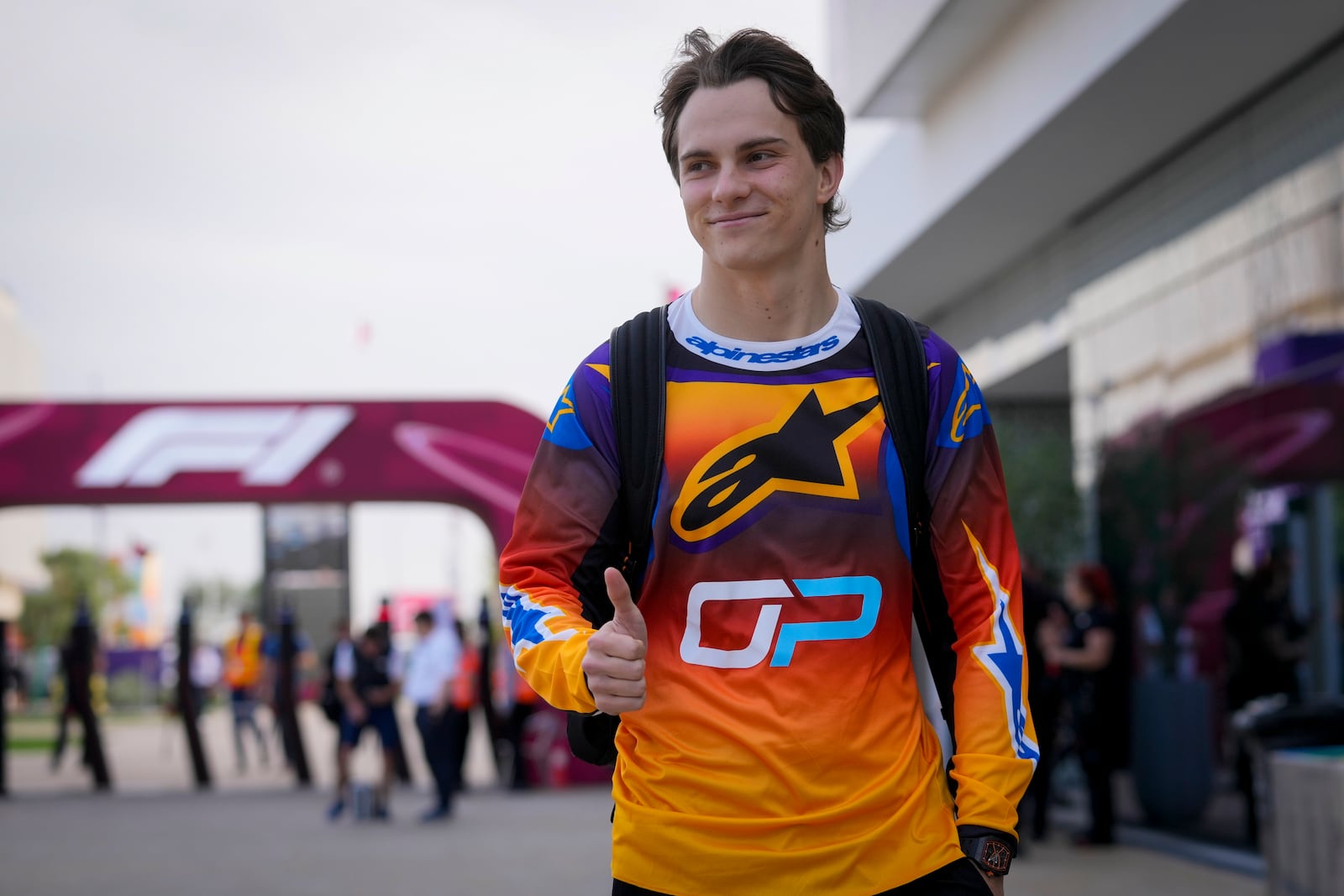 McLaren driver Oscar Piastri of Australia walks through paddock as he arrives at the Lusail International Circuit in Lusail, Qatar, ahead of the Qatar Grand Prix, Thursday, Nov. 28, 2024. (AP Photo/Darko Bandic)