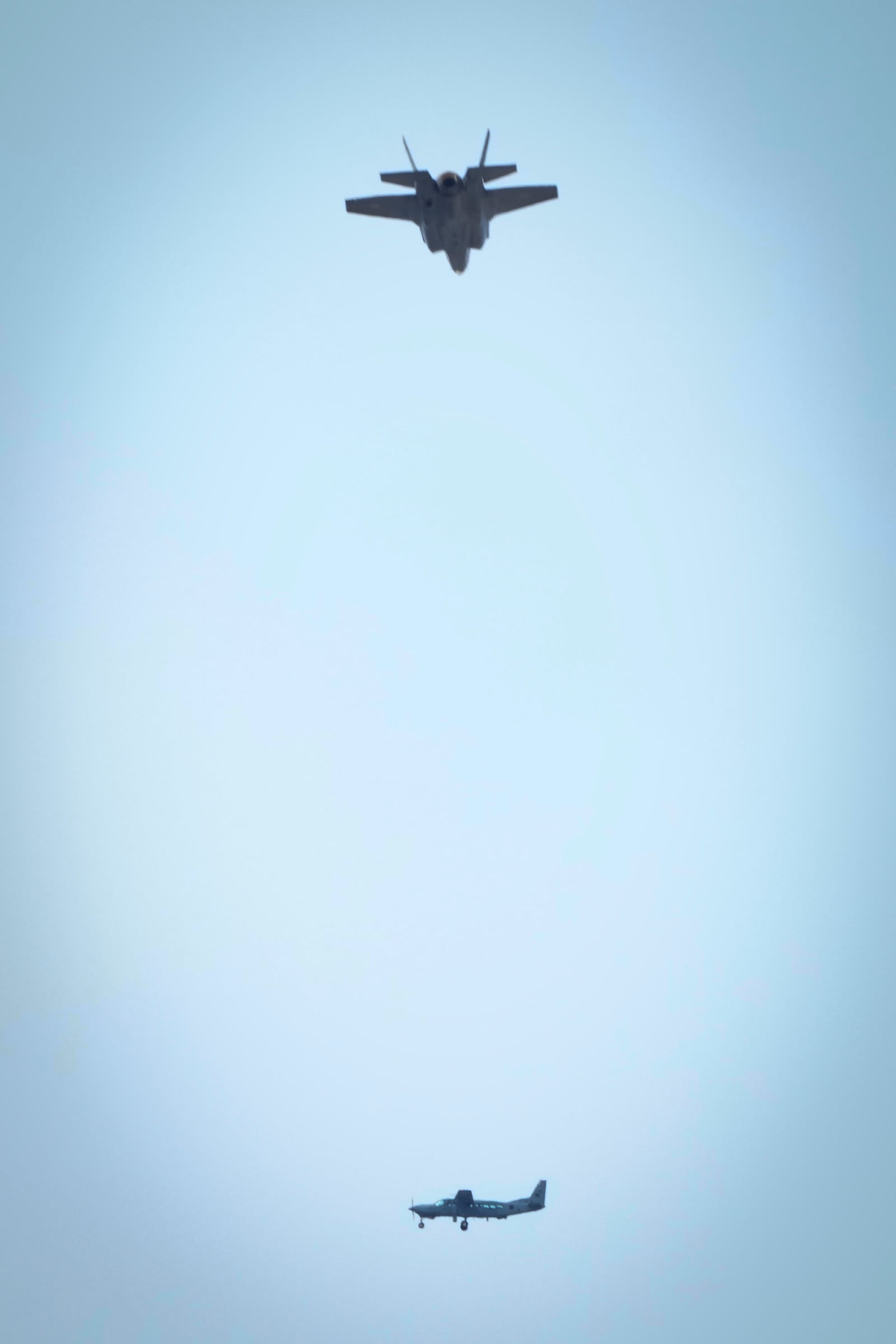 An Israeli fighter jet flies over a Lebanese airforce Cessna plane during the funeral ceremony of Hezbollah's former leader Hassan Nasrallah and his cousin and successor Hashem Safieddine in the Sports City Stadium in Beirut, Lebanon, Sunday, Feb. 23, 2025. (AP Photo/Hussein Malla)