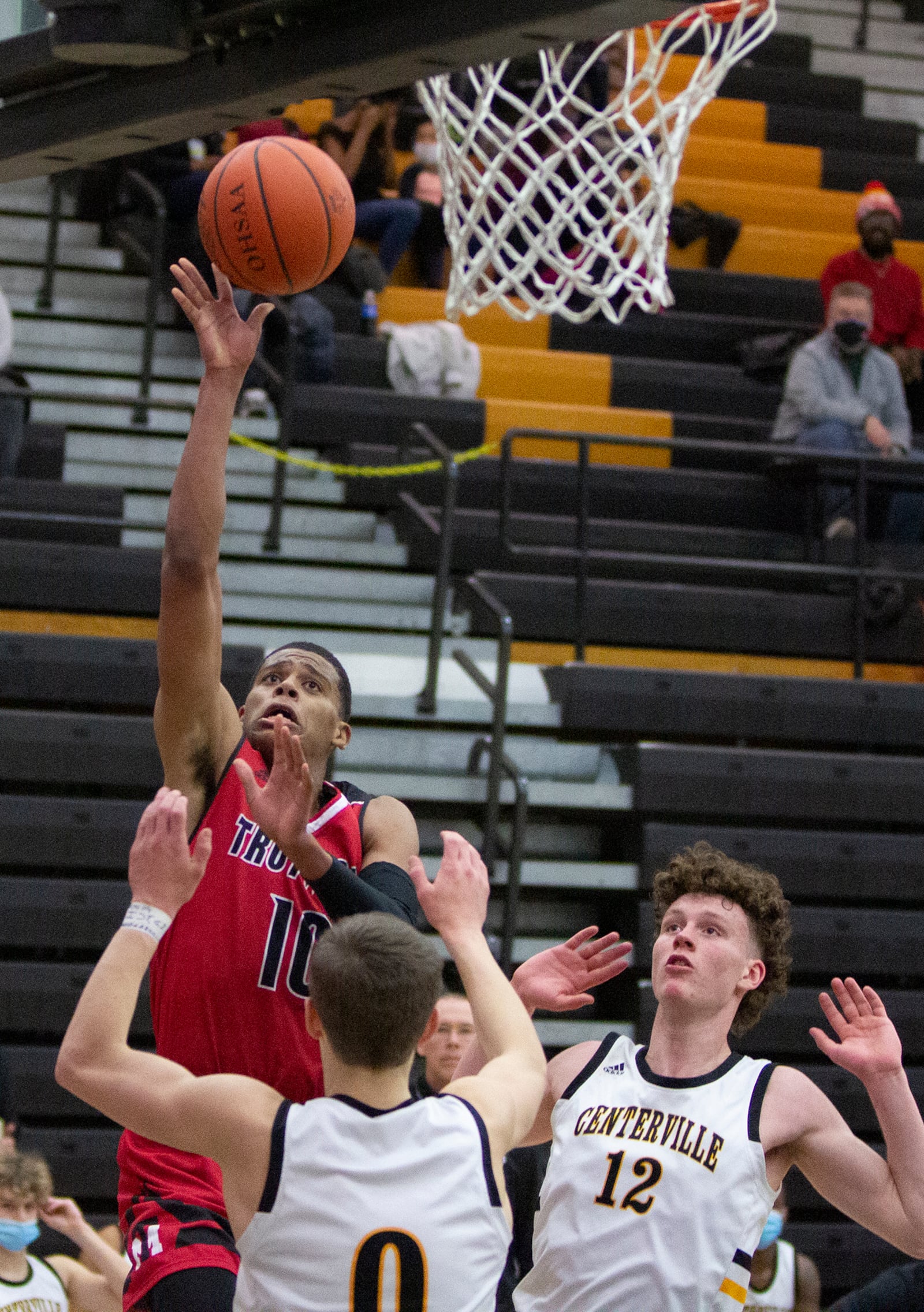 Trotwood-Madison’s Anthony McComb shoots over Centerville’s Gabe Cupps (0) and Tom House on Feb. 2, 2021. McComb scored 36 points in an 89-71 loss. Jeff Gilbert/CONTRIBUTED