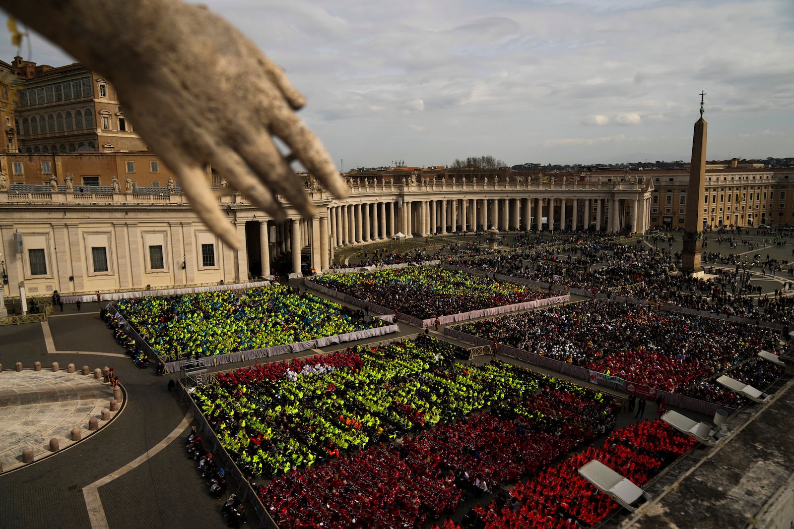 Members of different organizations of volunteers follow Cardinal Michael Czerny, delegate of Pope Francis who is being treated for pneumonia at Rome's Agostino Gemelli Polyclinic, celebrating a mass for the world of volunteers in St. Peter's Square at The Vatican, Sunday, March 9, 2025. (AP Photo/Francisco Seco)