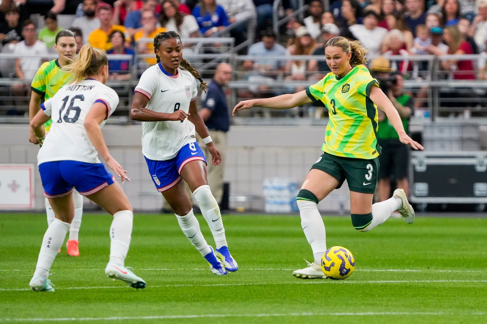 Australia defender Winonah Heatley (3) looks to pass the ball while guarded by United States midfielder Claire Hutton (16) and United States midfielder Jaedyn Shaw during the first half of a group stage match in the SheBelieves Cup women's soccer tournament, Sunday, Feb. 23, 2025, in Glendale, Ariz. (AP Photo/Samantha Chow)