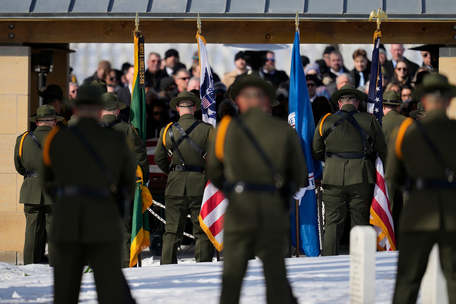 U.S. Border Patrol agent David Maland is recognized with military honors before his burial at Fort Snelling National Cemetery in Minneapolis, on Saturday, Feb. 22, 2025. (AP Photo/Abbie Parr)