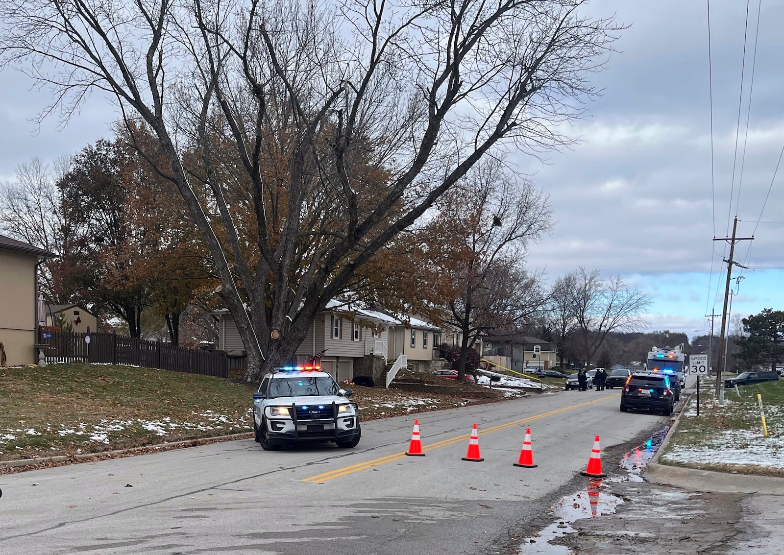 Police vehicles with flashing lights surround the Edwardsville, Kan., home of former police detective Roger Golubski on Monday, Dec. 2, 2024. (AP Photo/Heather Hollingsworth)