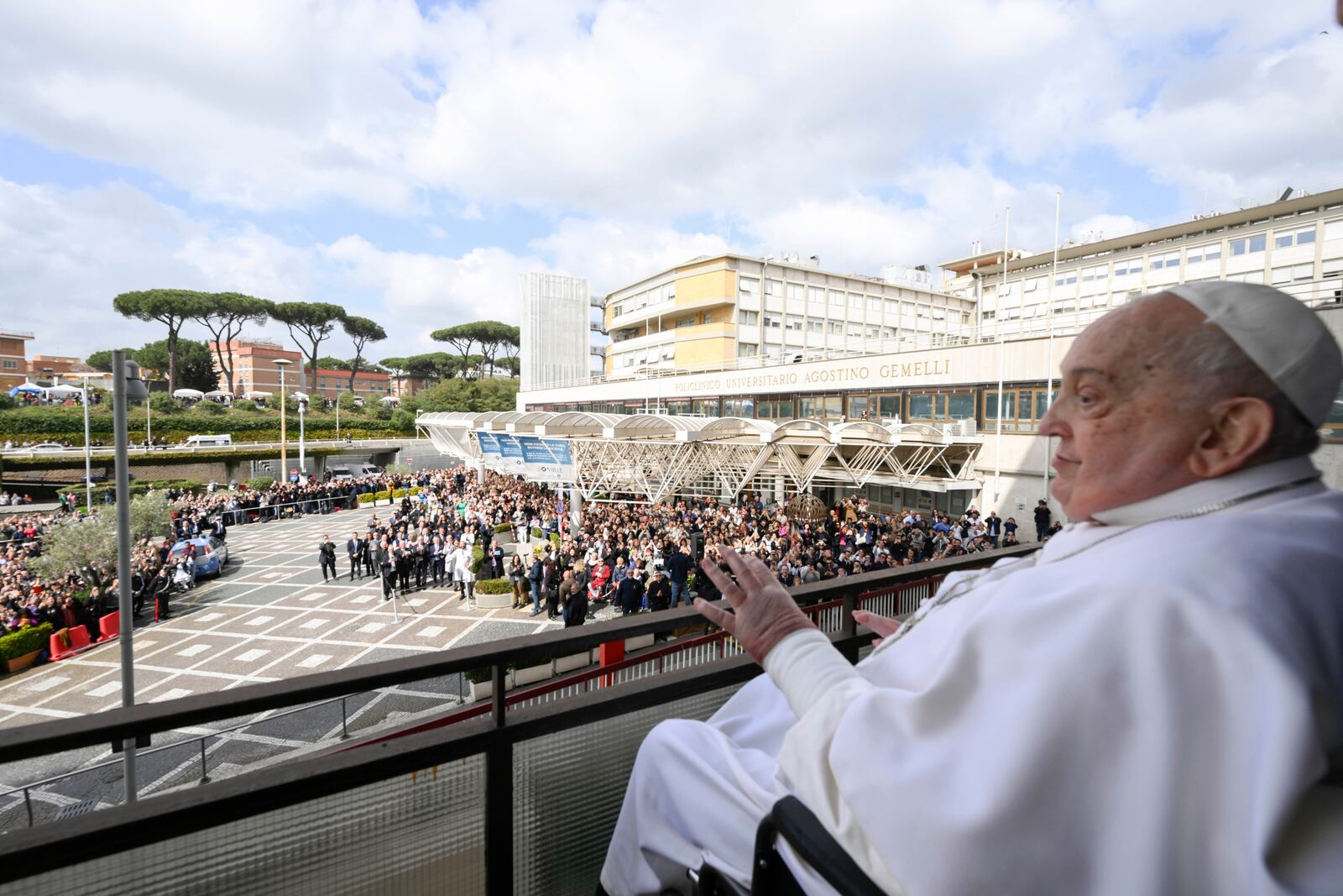 Pope Francis waves as he appears at a window of the Agostino Gemelli Polyclinic in Rome, Sunday, March 23, 2025, where he has been treated for bronchitis and bilateral pneumonia since Feb. 14. (Francesco Sforza/Vatican press office via AP)